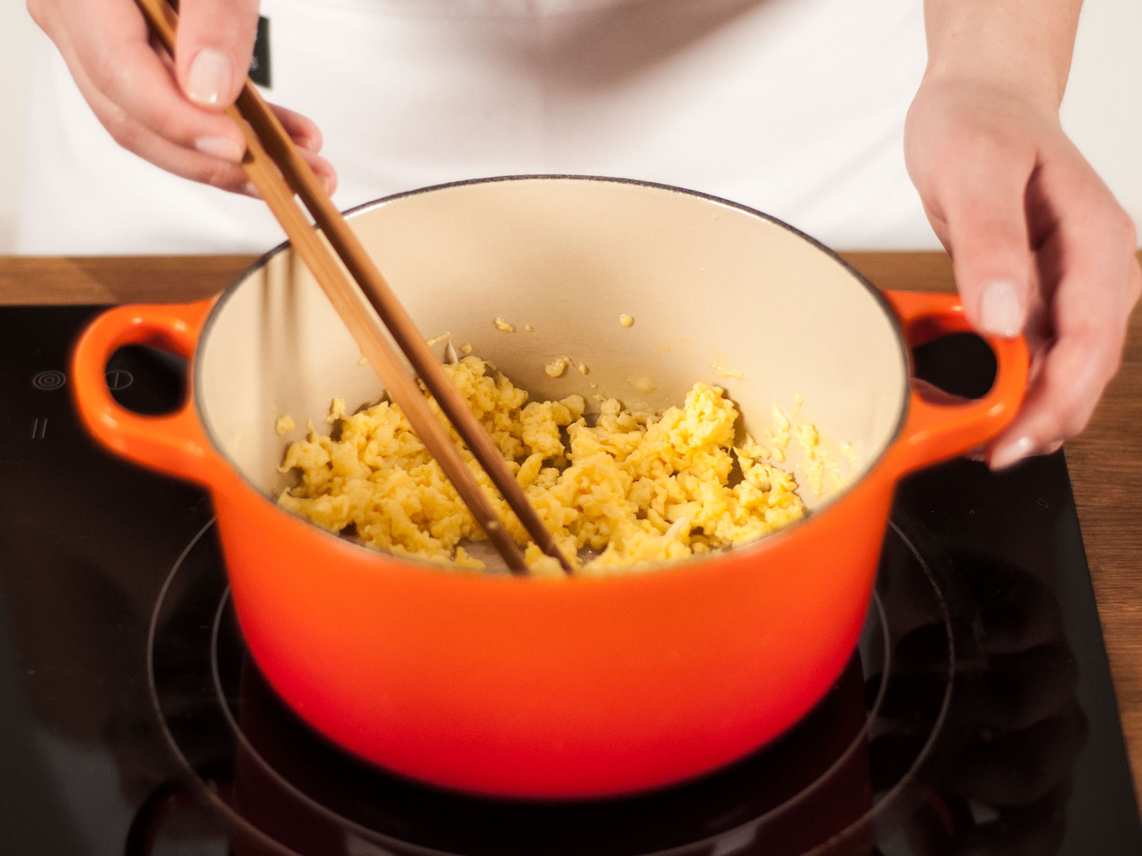 In a small saucepan, heat parts of the vegetable oil over medium-high heat until hot. Add eggs to pan and scramble for approx. 3 – 5 min. until eggs are fluffy and broken down into small pieces. Transfer to a plate and set aside to cool down.