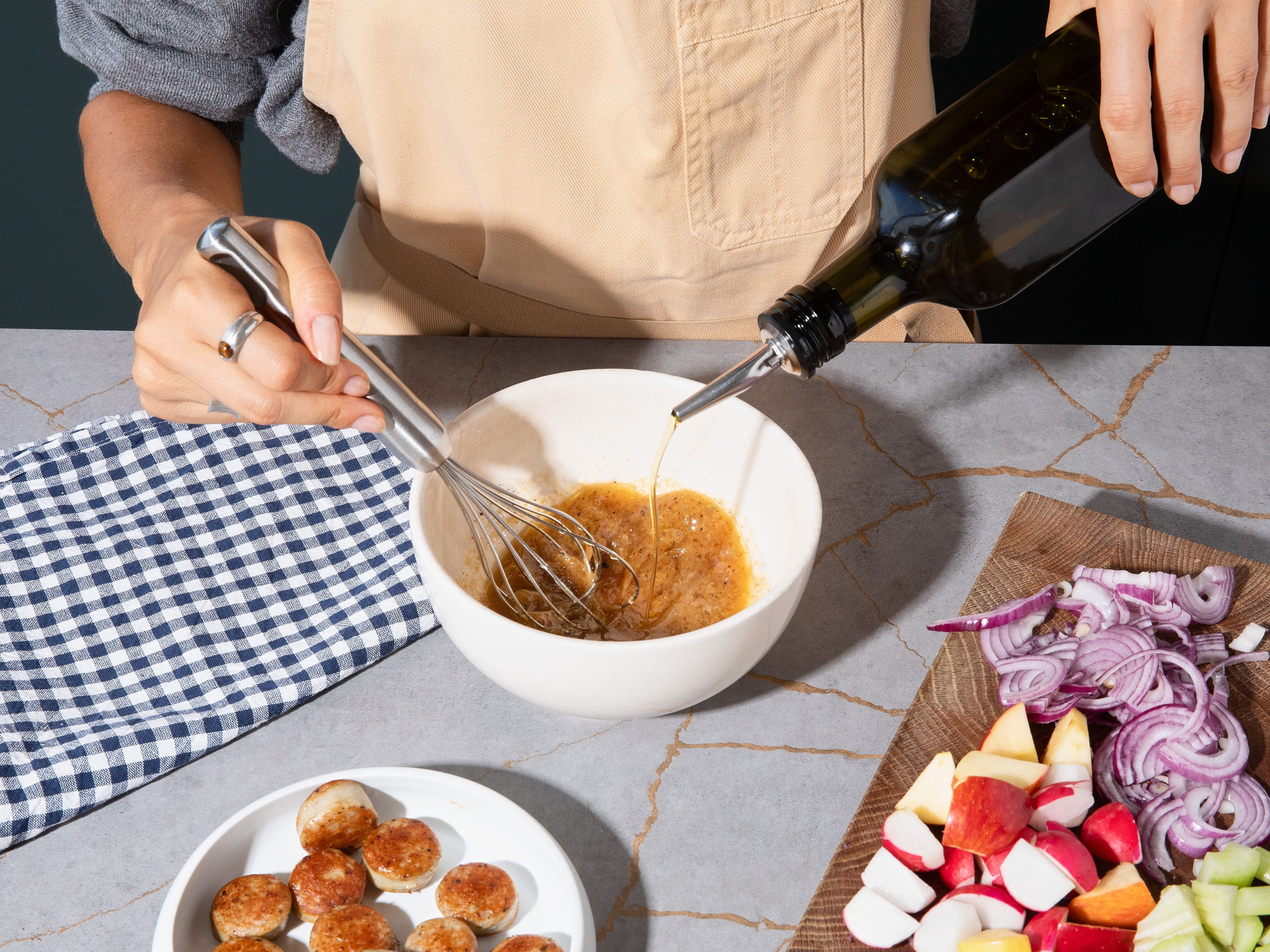 Whisk olive oil, apple cider vinegar, sweet mustard, horseradish, maple syrup, salt, and pepper until smooth. Add the fruit and vegetables to a large bowl together with the toasted pretzels and bratwurst and toss with the dressing. Garnish with chives and parsley and serve immediately.
