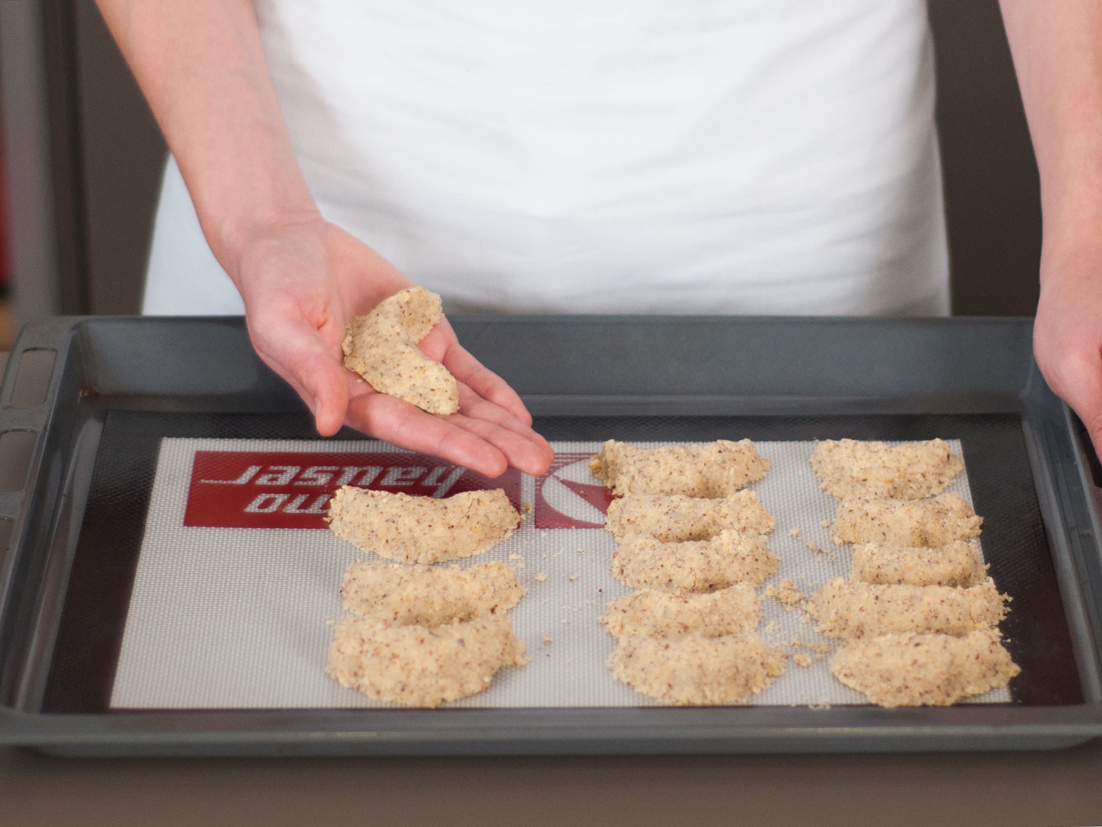 Knead dough to a ball and then form crescent shaped cookies. Place on a lined baking sheet and bake in a preheated oven at 170°C/335°F for approx. 8 – 10 min.