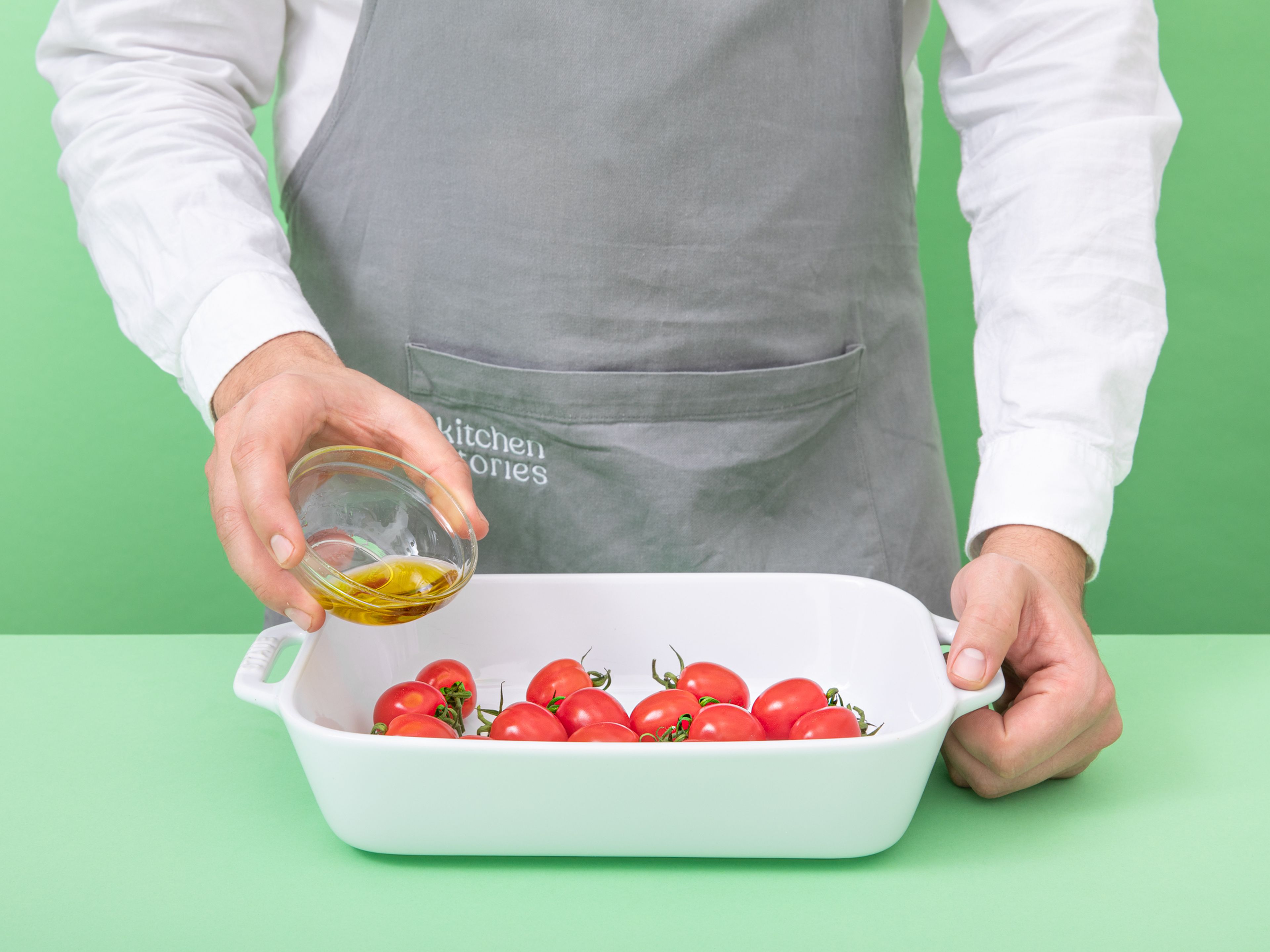 To prepare the roasted tomatoes, combine cherry tomatoes with olive oil, salt, and pepper in a baking dish. Transfer to the oven and roast at 200°C / 400°F for approx. 12 min. Add pine nuts to a small, dry pan and toast over medium-low heat, then set aside.