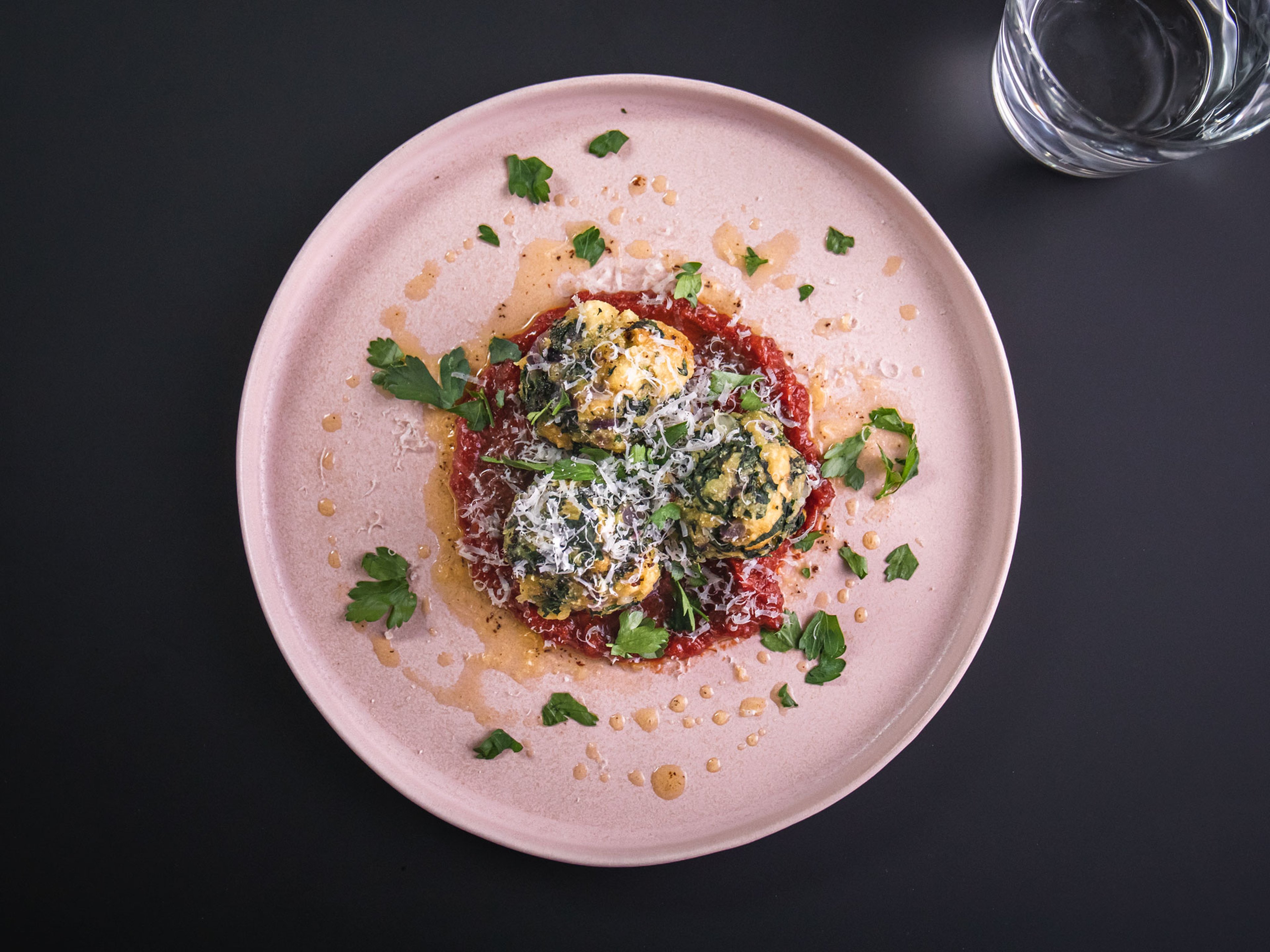 Spinach and cheese dumplings with tomato-date sauce