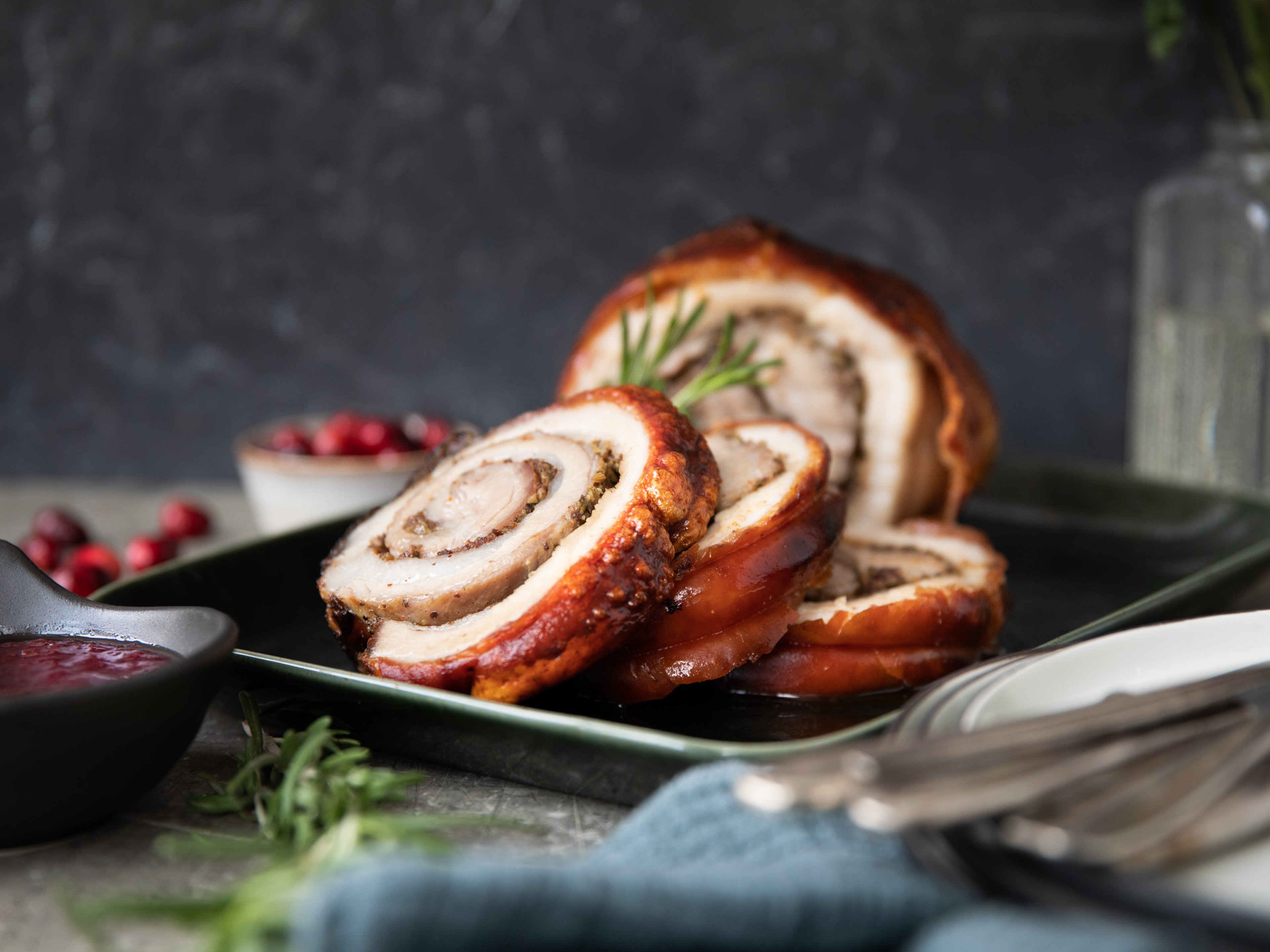 Crispy rolled pork belly with cranberries and herbs