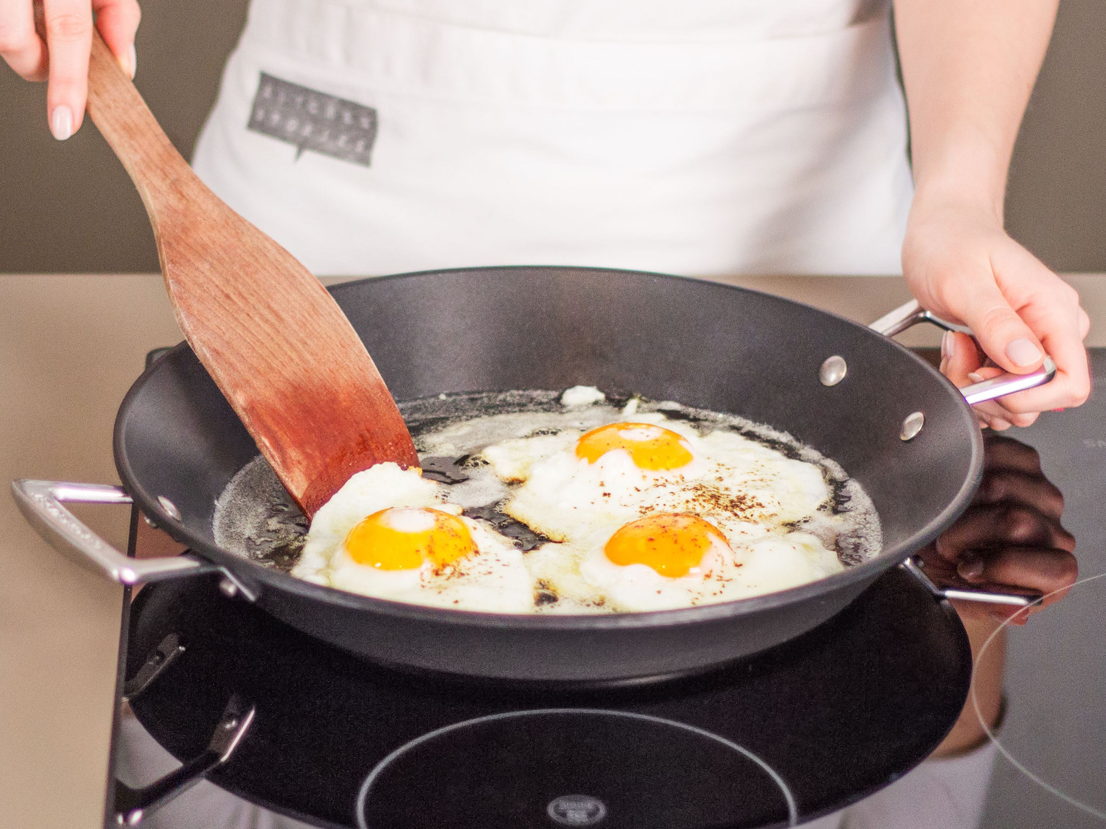 In a separate large frying pan, fry eggs in some vegetable oil over medium heat for approx. 2 – 4 min. until whites are opaque and yolks begin to set. Then, transfer fried eggs to pan with meatballs. Enjoy with a side of our signature hot chili sauce!
