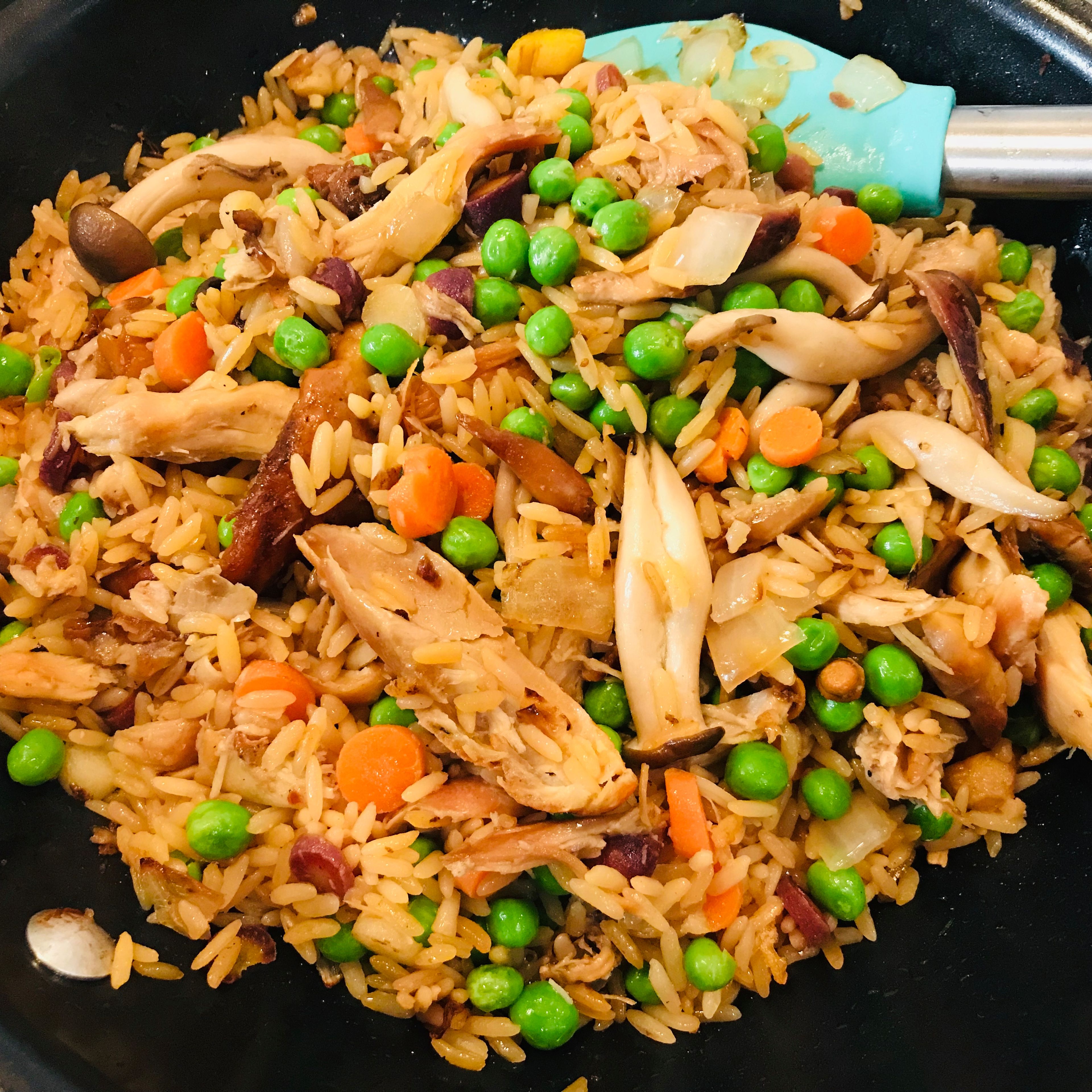 Add raw mixed veggies into the pan with chicken, stir fry on medium low for 2 minutes or until any released moisture is gone. Then, add cooked rice and frozen veggies (if any) and continue stir-frying for 3-5 minute. Make sure all ingredients are well mixed and cooked.