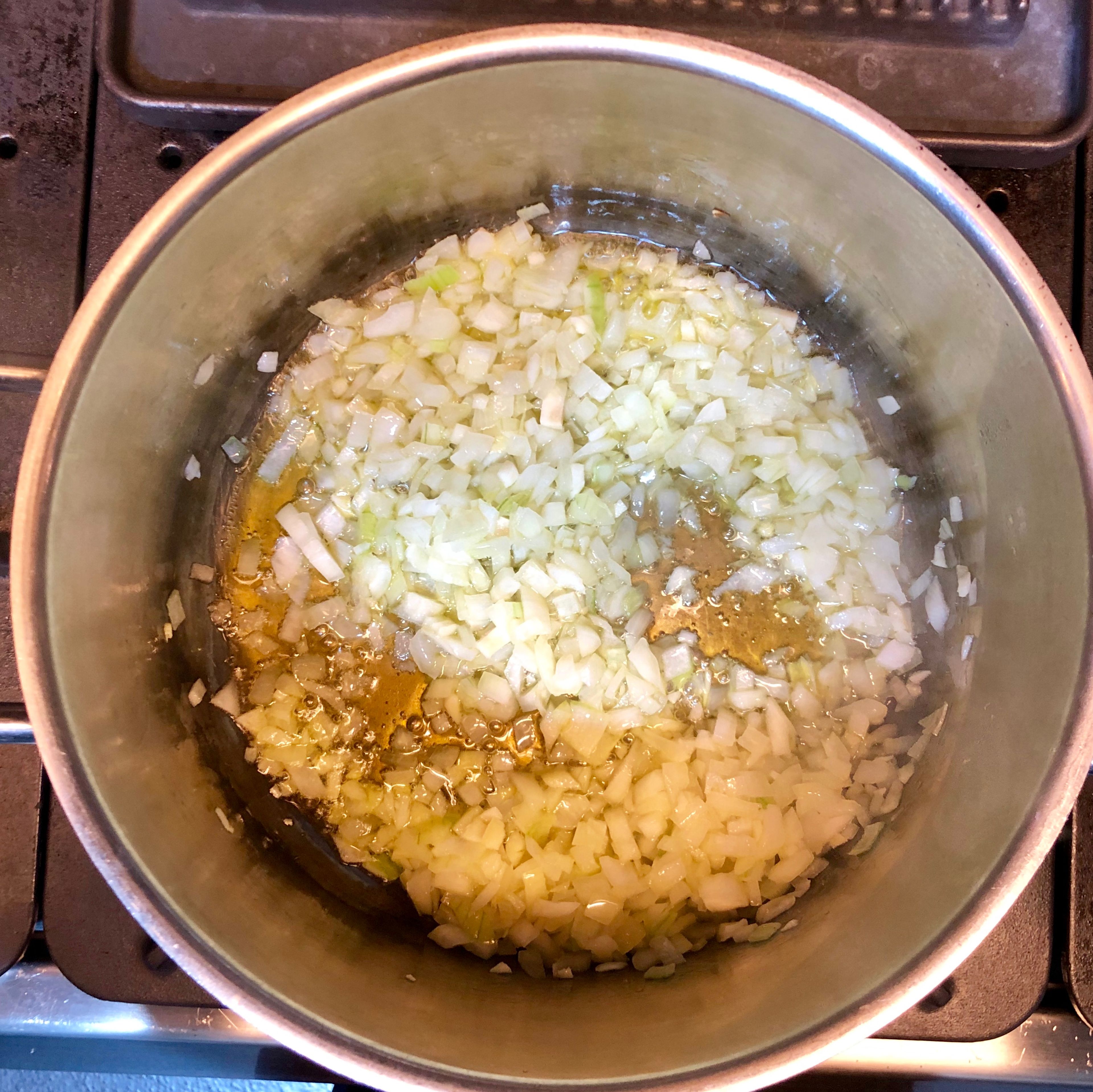Heat olive oil in a stockpot. Add onion and garlic and cook until soft but not brown, about 5 minutes.