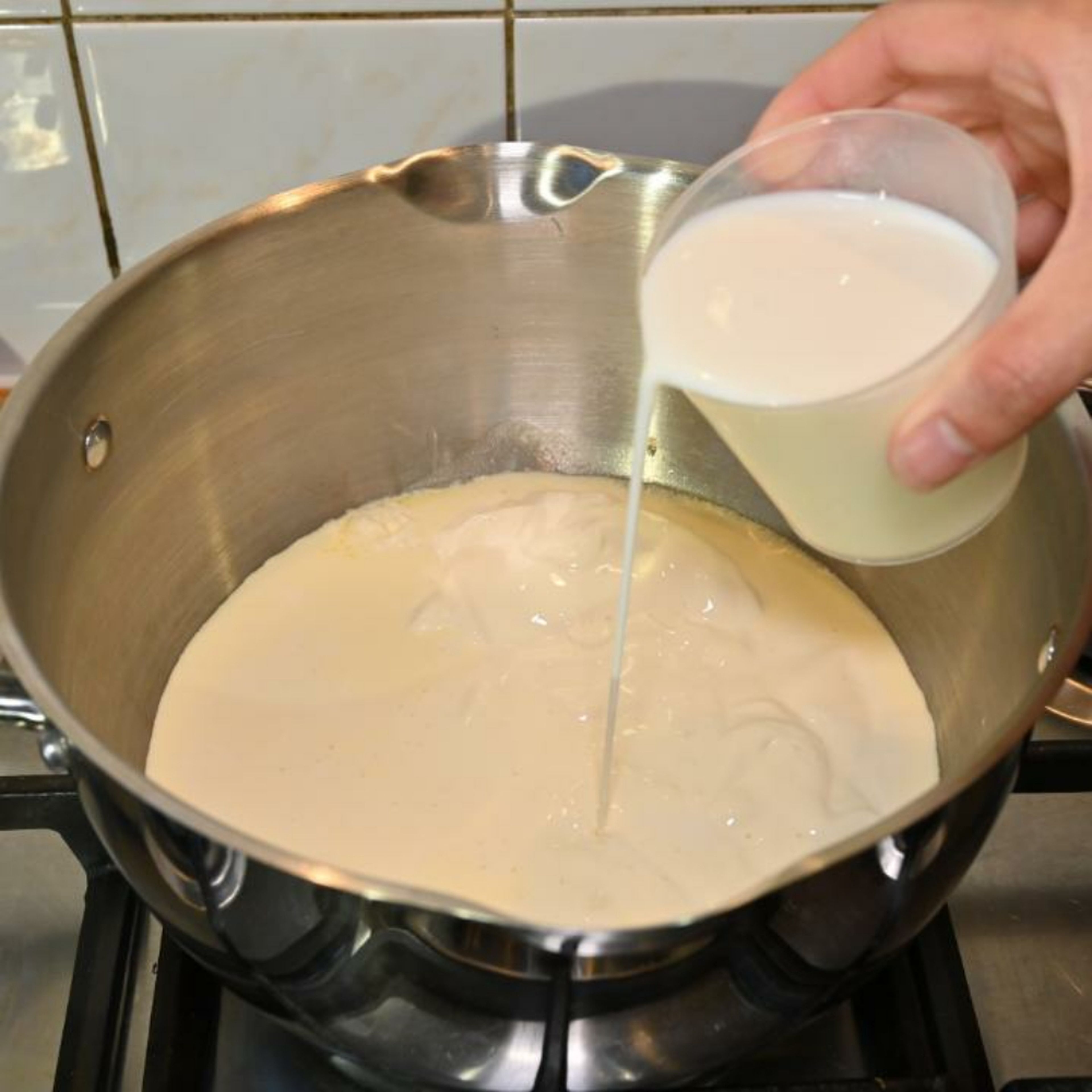 In a saucepan over low to medium heat, simmer the double cream, milk, and caster sugar. 
Keep stirring to dissolve the sugar and then add vanilla essence.