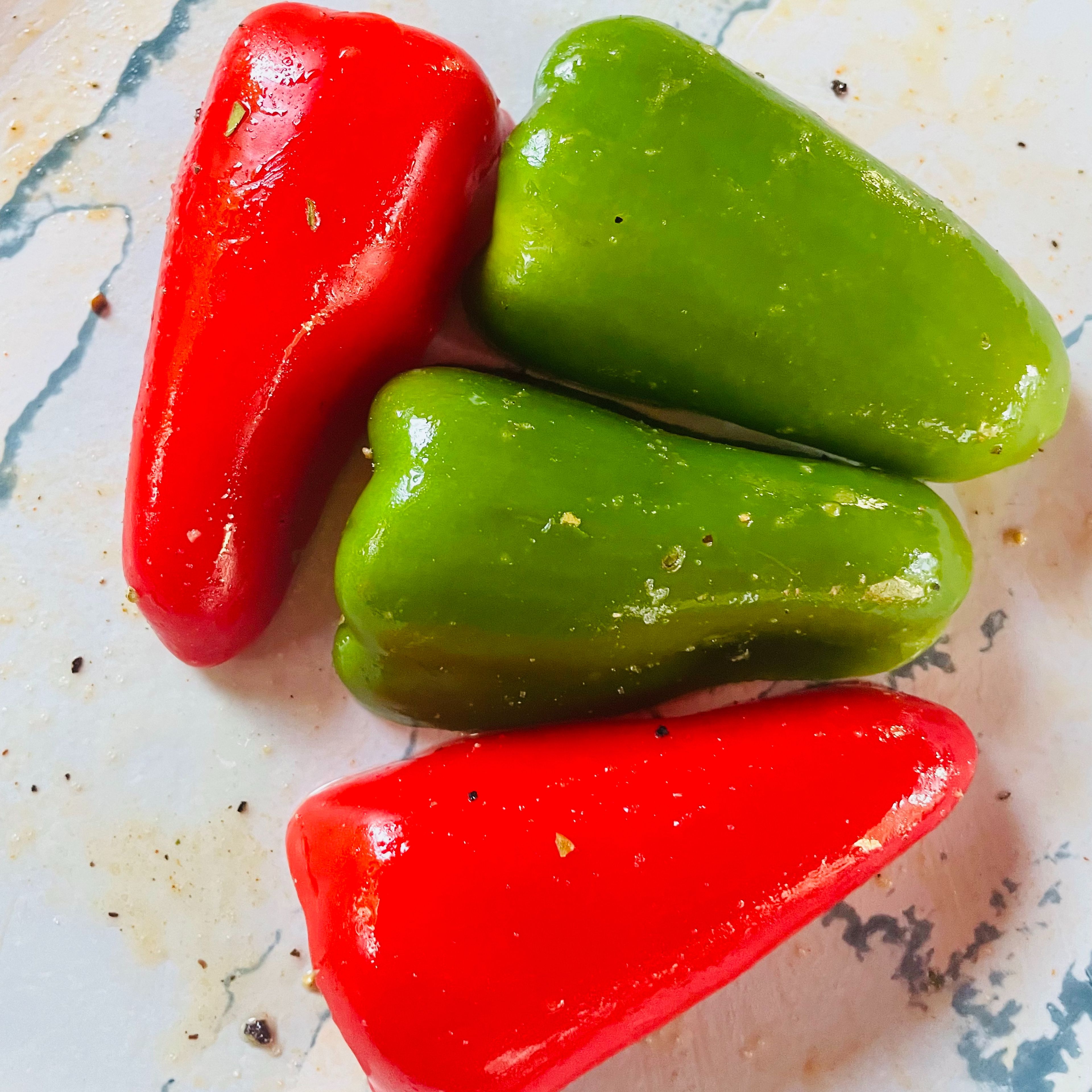 Seasoning bell peppers with salt, mixed herb and olive oil