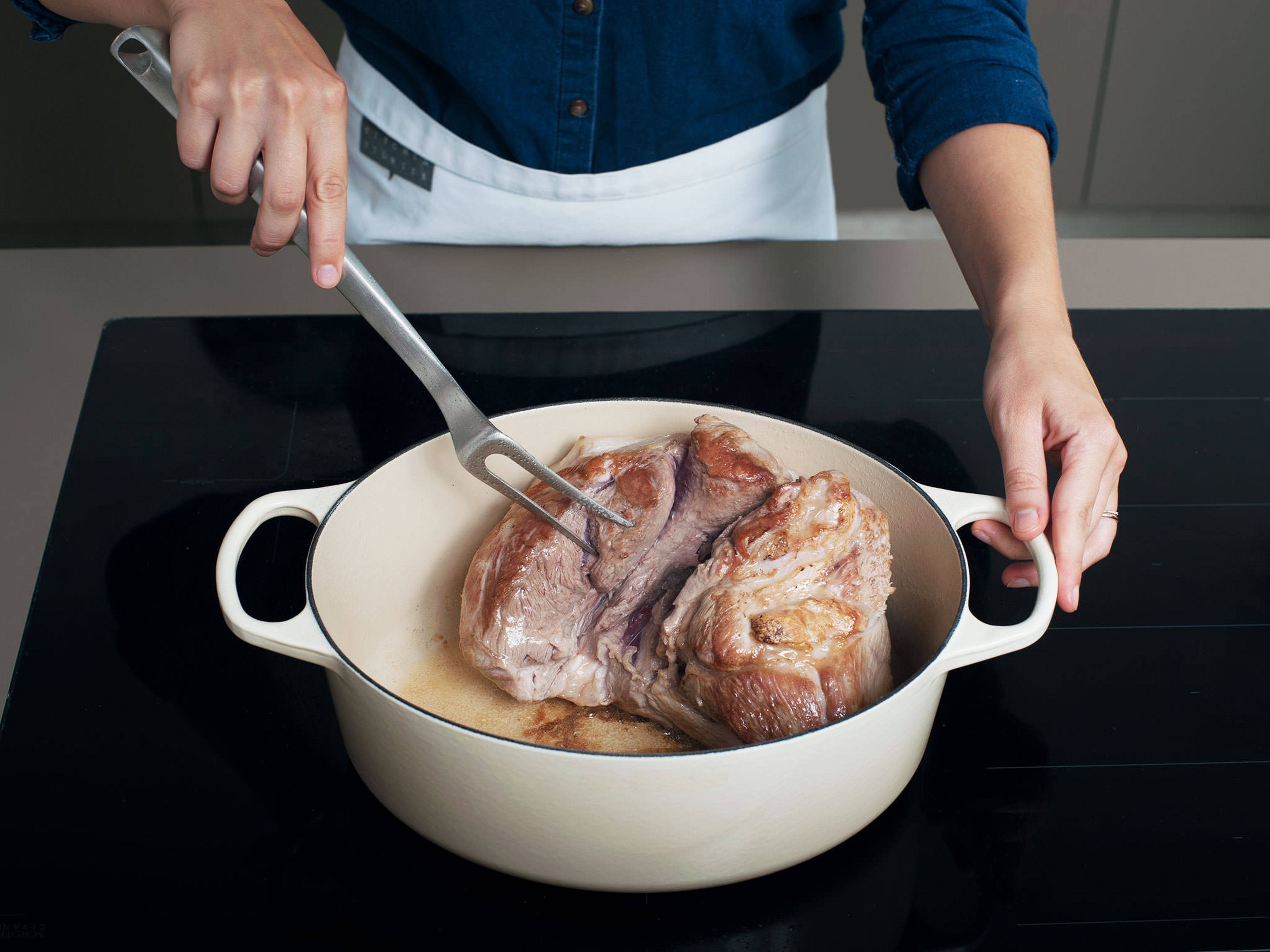 Trim excess fat from pork shoulder, if desired. Season with salt and pepper. Heat a large, ovenproof pot over medium-high heat. Brown pork on all sides, then transfer to plate and set aside.