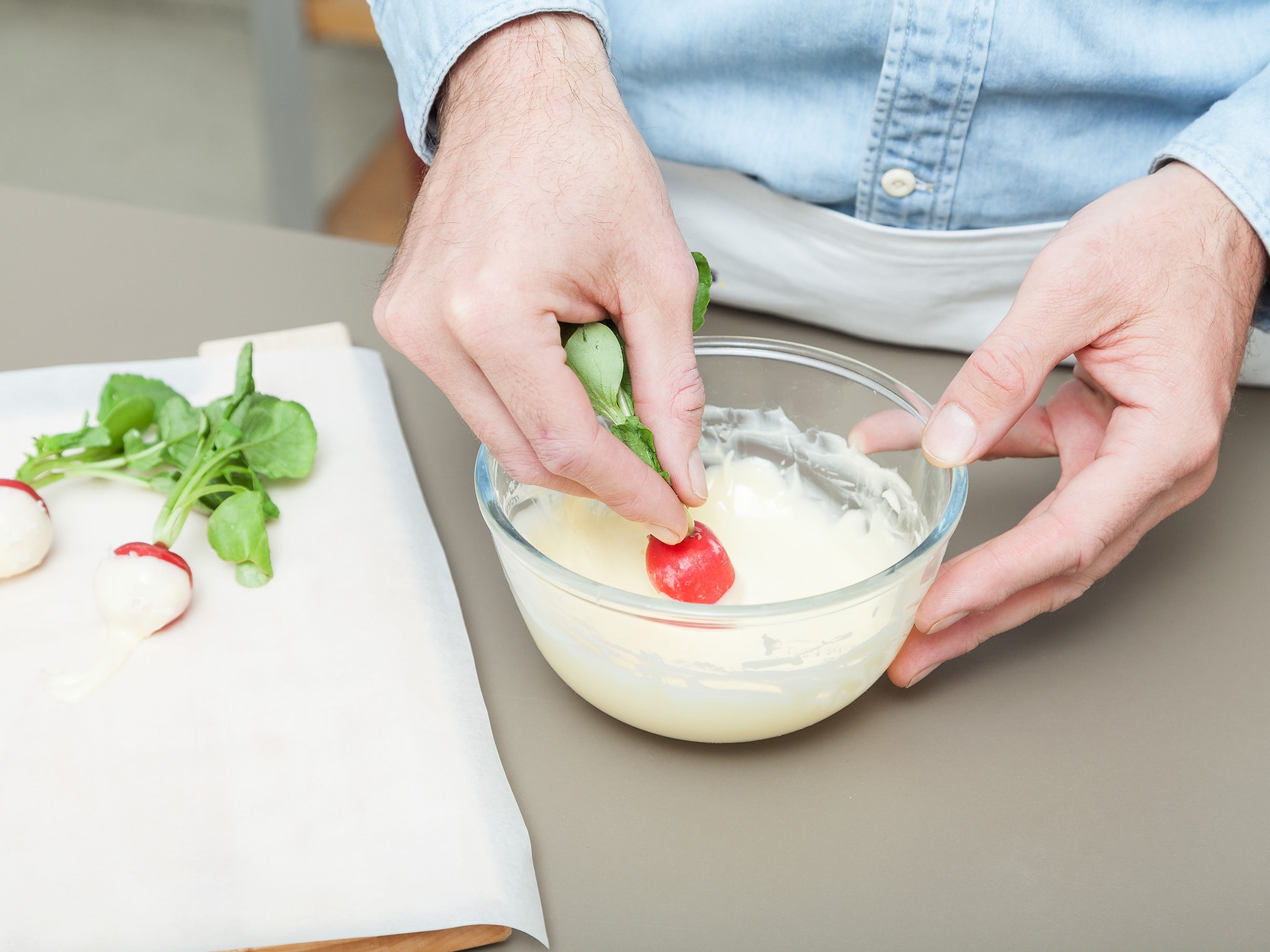 Dip the radishes halfway in the butter once, then again, and gently shake off any excess. Sprinkle some flaky sea salt over the butter dipped radish and set on a parchment lined plate. Refrigerate until butter is set, approx. 10 min. Serve immediately and enjoy!