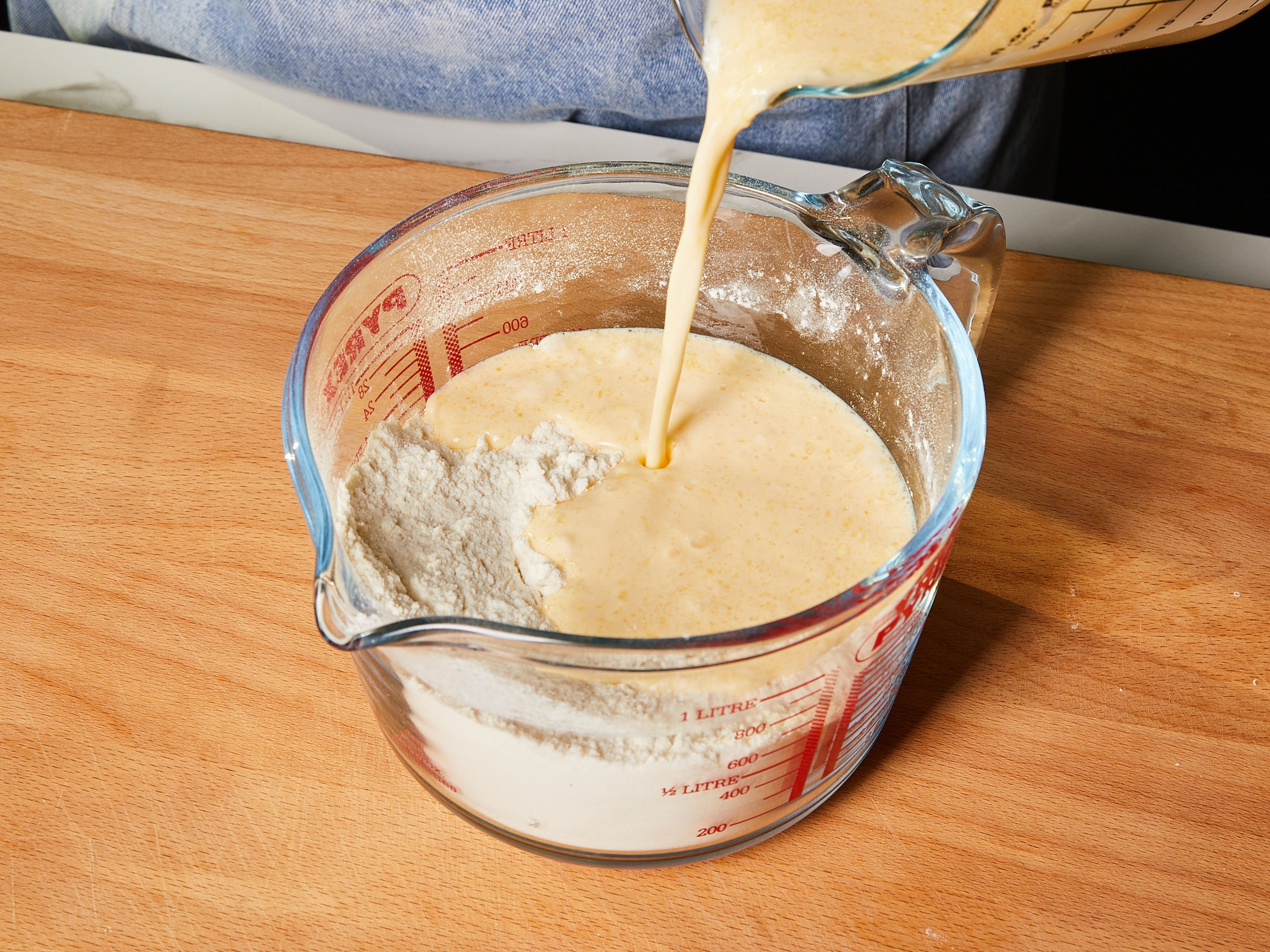 Now pour the liquid mixture into the dry ingredients in the large measuring cup and mix until everything is just combined – it should look a little lumpy.