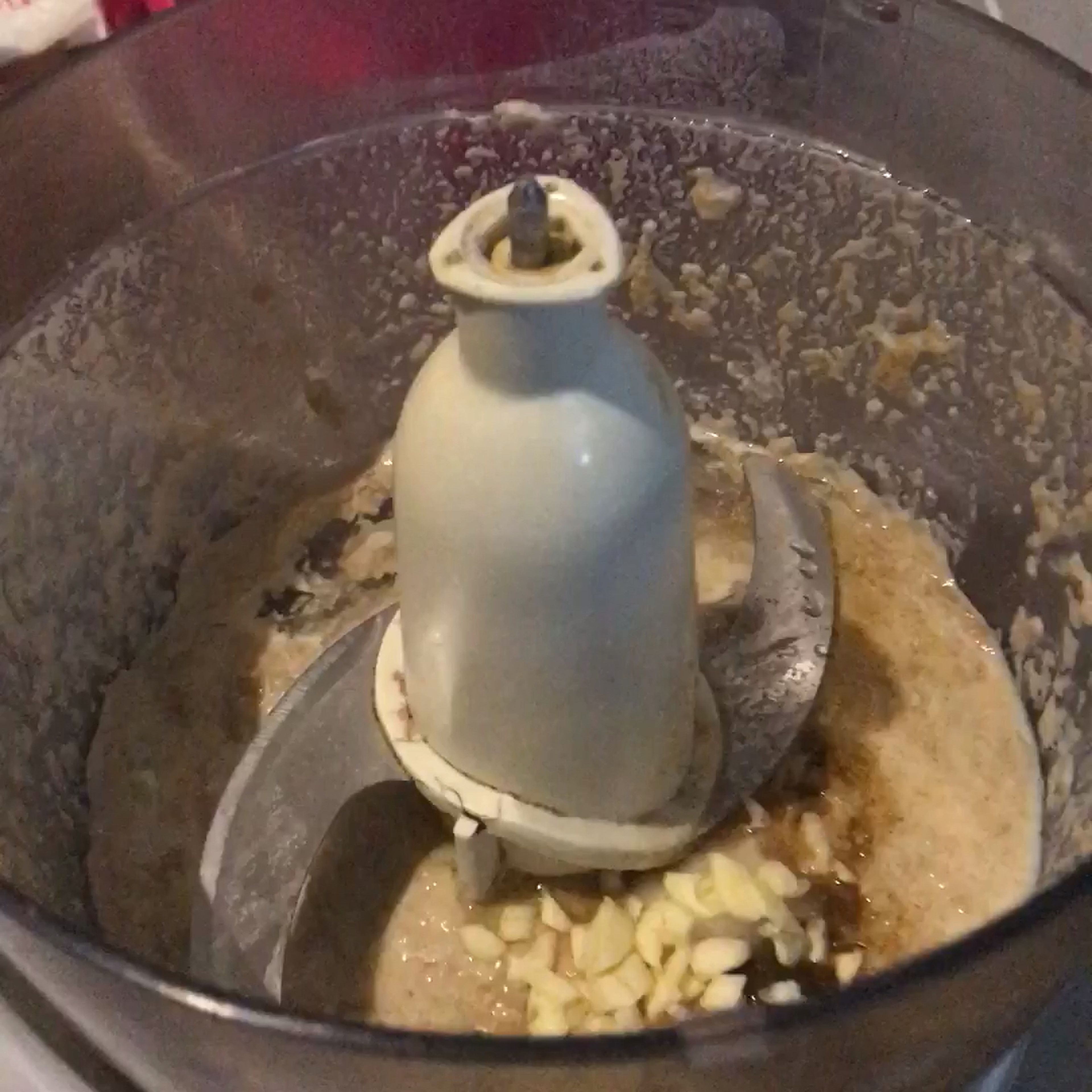 Add the oil, ground cumin, salt and garlic clove in the food processor. Stop the food processor and scrape the sides of back in the centre when you process the food.