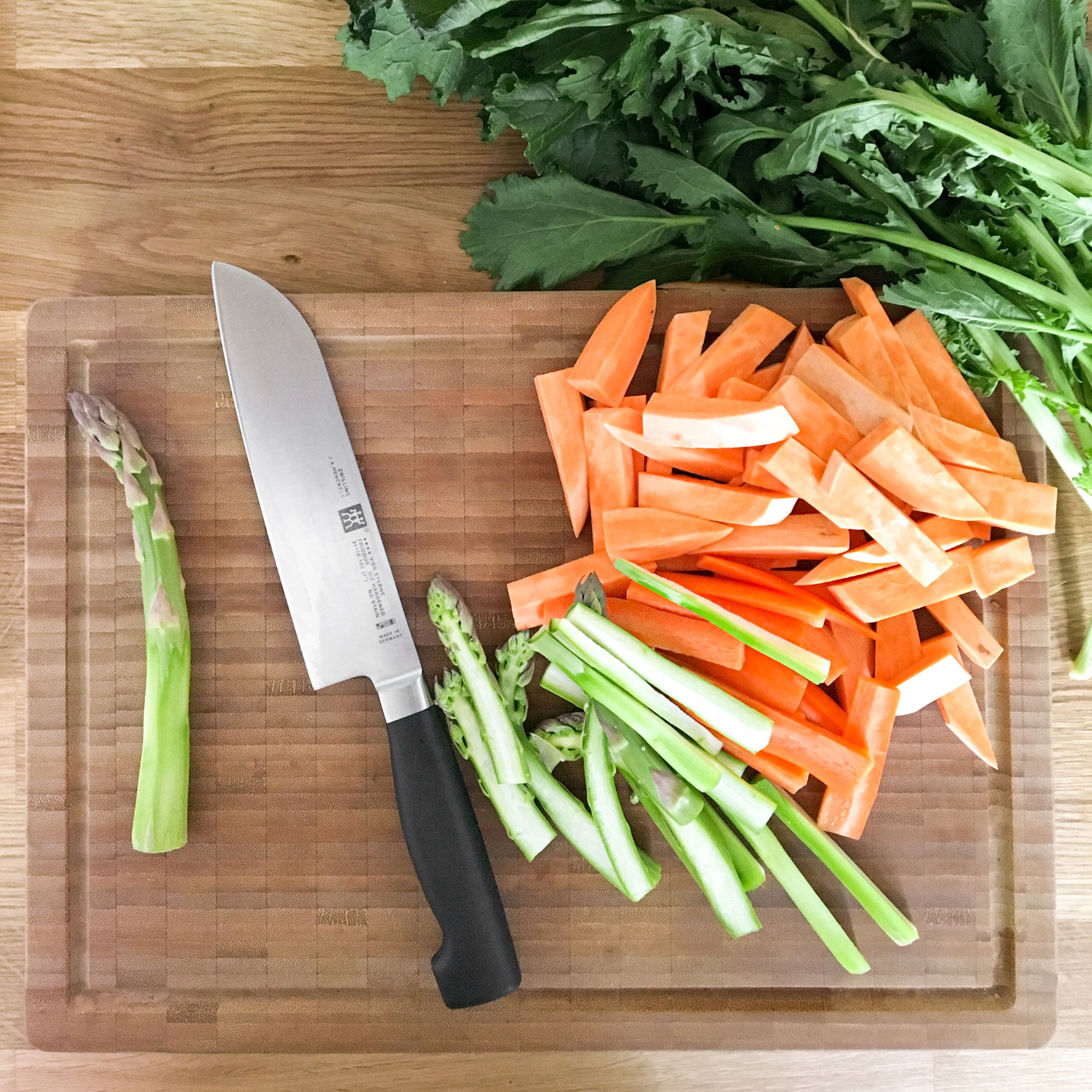 Peel and slice the sweet potato, carrot, and asparagus into strips. Cut turnip greens into small pieces. Roughly chop pistachios. Cube the cucumber. Deseed the pomegranate.