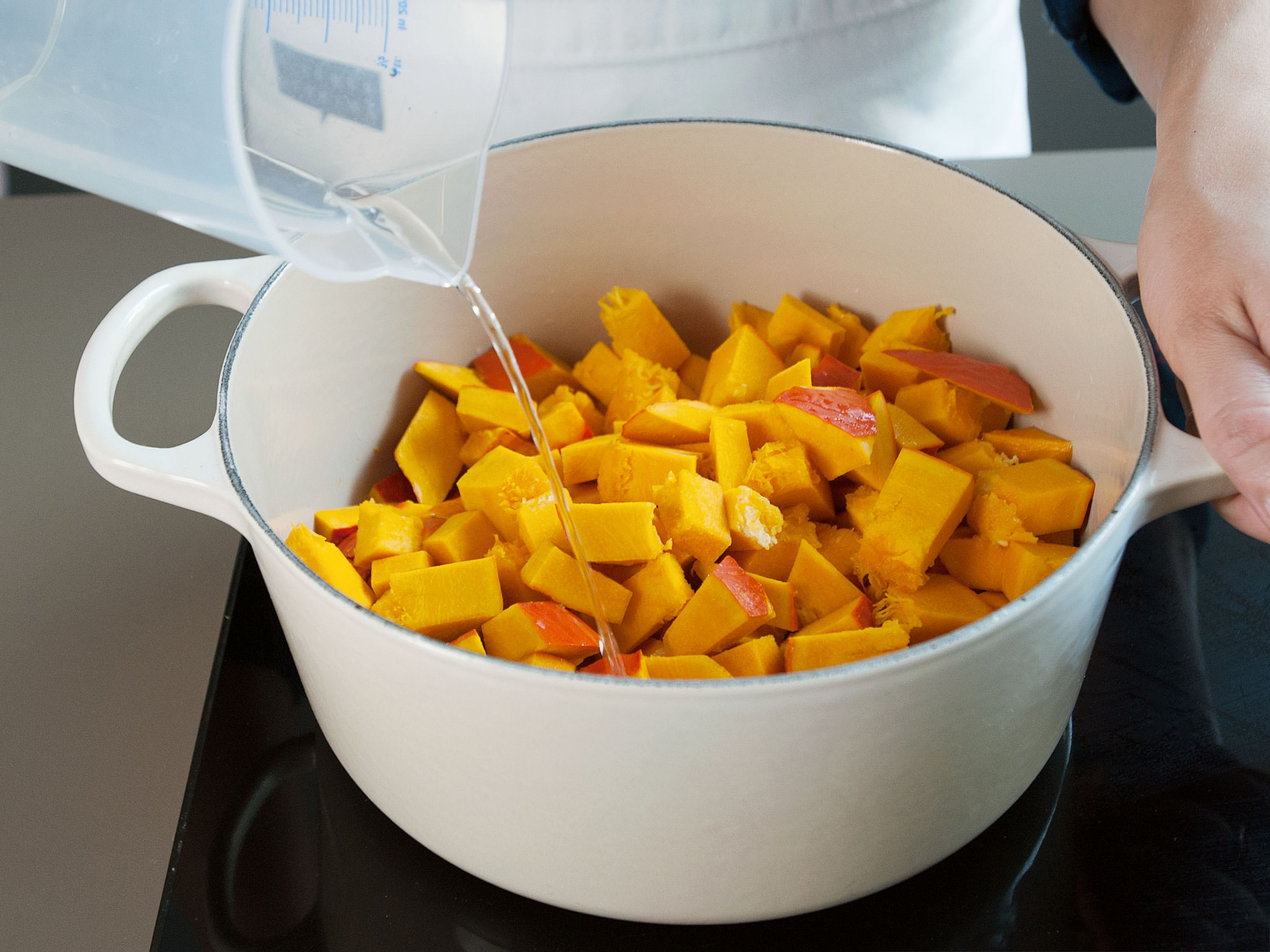 To prepare pumpkin purée, deseed and cut Hokkaido pumpkin into pieces. Place in a Dutch oven along with some water. Steam over medium heat with lid slightly cracked until soft, approx. 25 min.