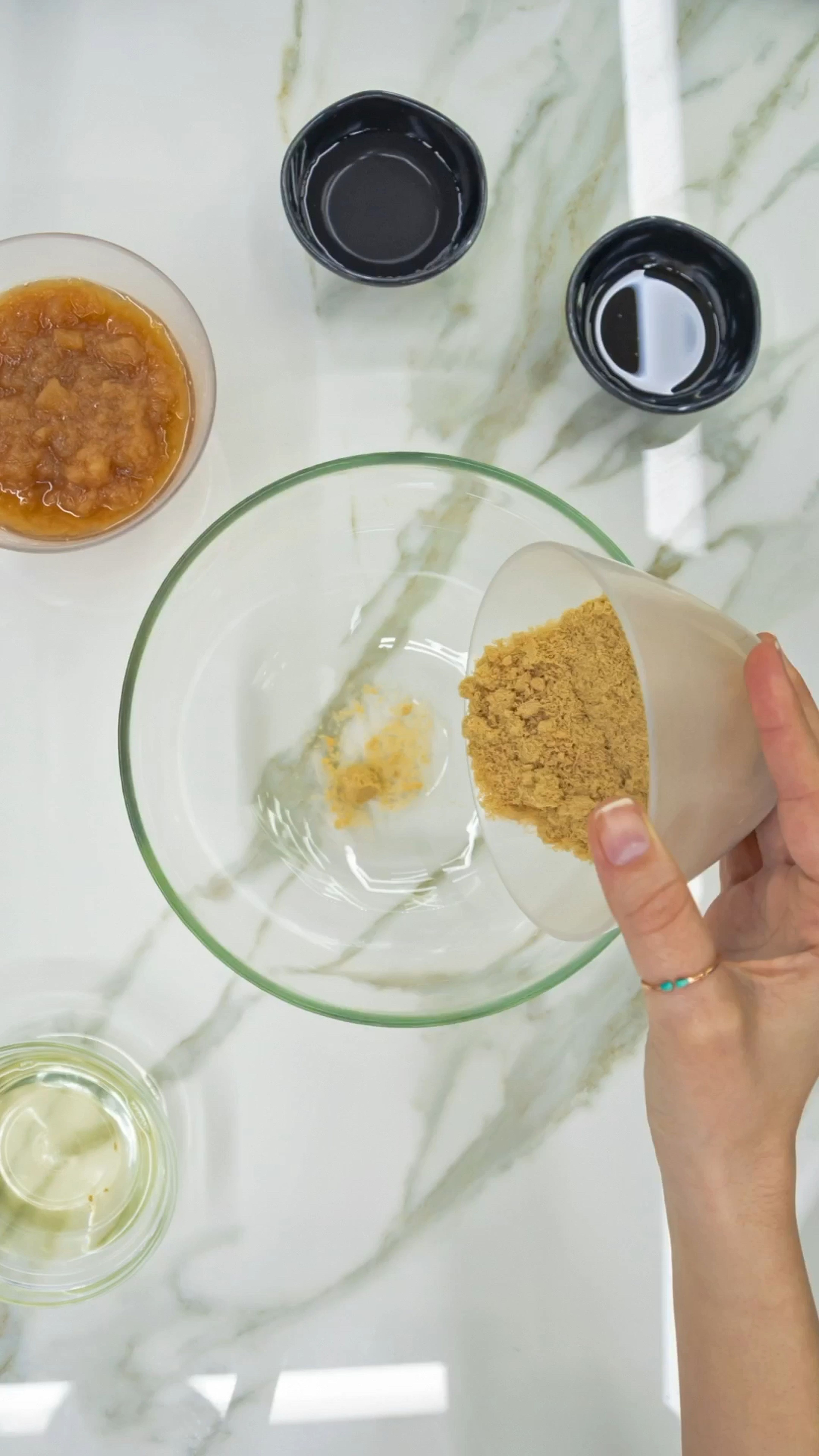 In a separate bowl, mix the sugar, coconut oil, vinegar, and vanilla extract. Once combined, fold in the applesauce.