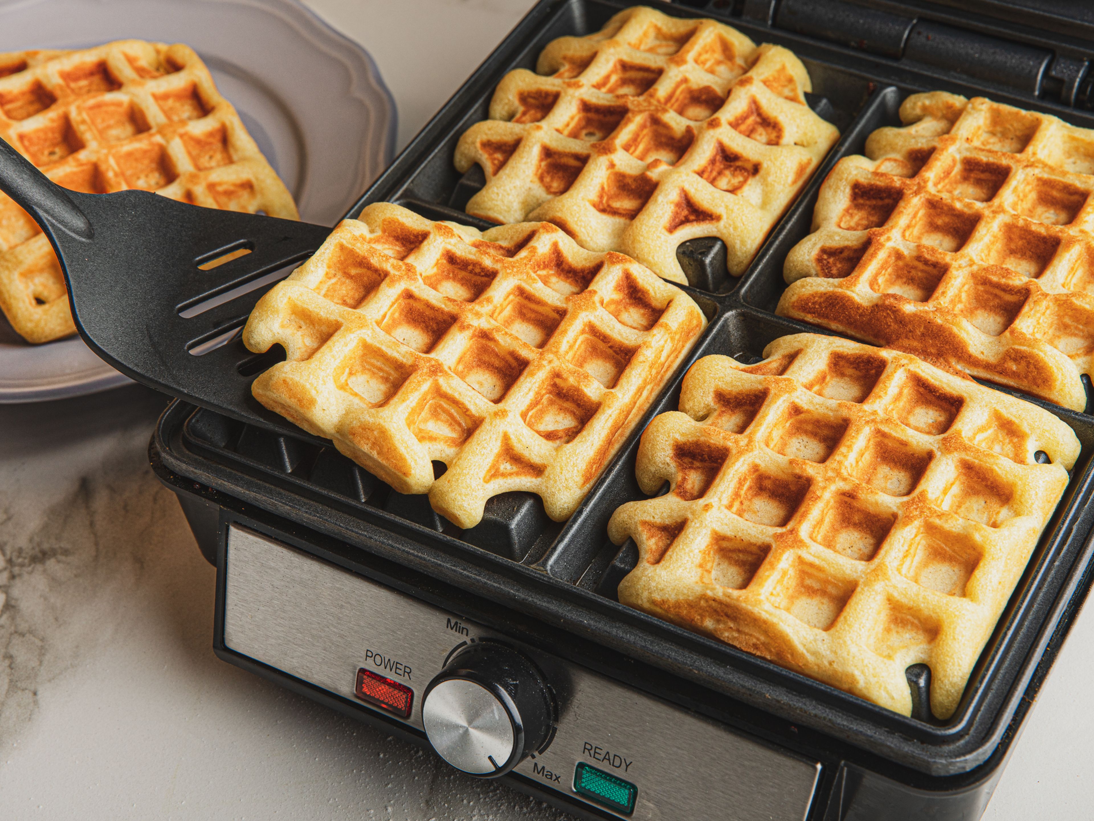 Grease the waffle iron with some vegetable oil. Then, add a spoonful of waffle batter, close the lid, and bake until crispy. Continue until the batter is used up. Enjoy waffles with jam, cream, butter and/or syrup!