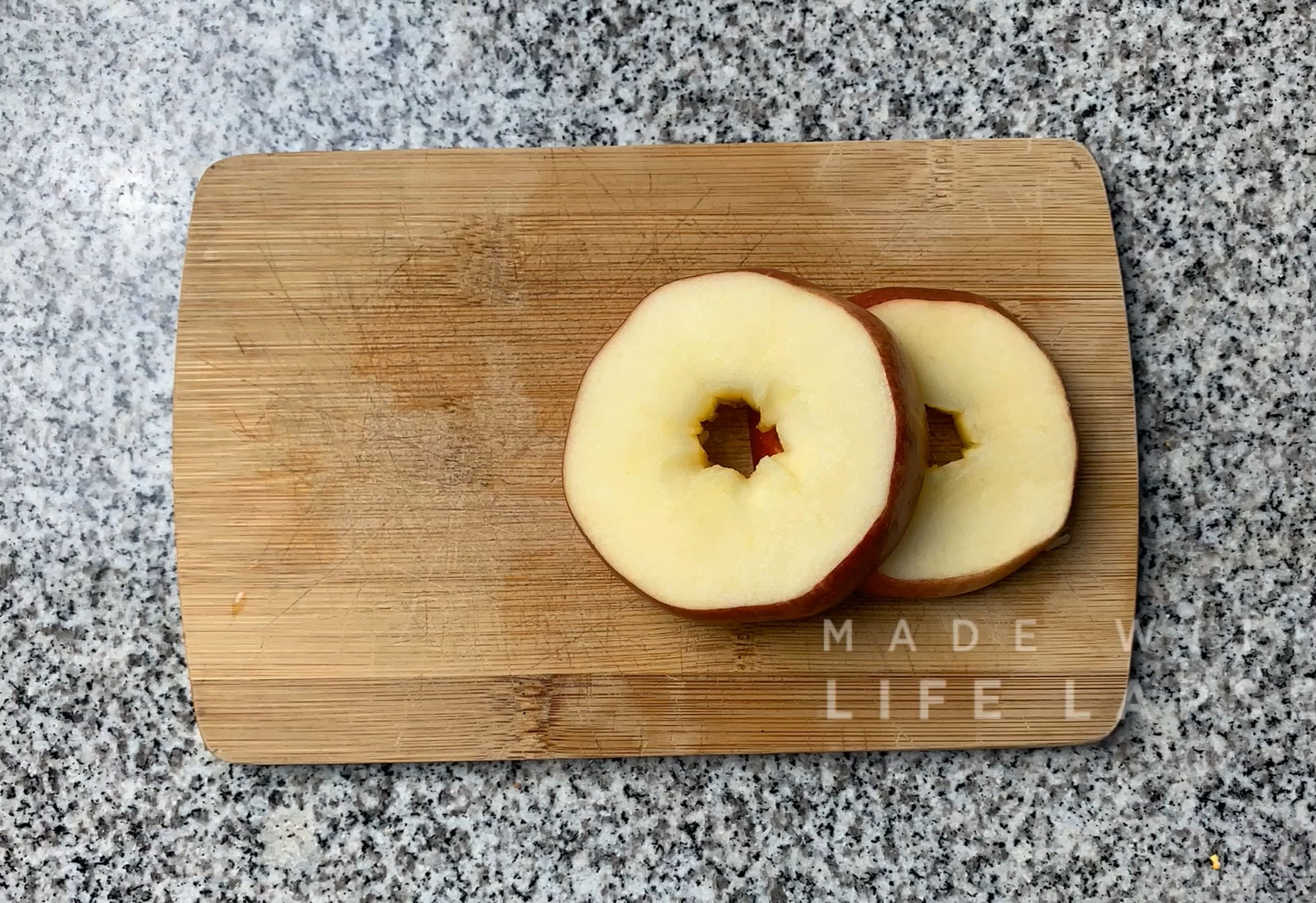 Cut the apple in 4 slices. To two of the slices add the yogurt and ground cinnamon and the other two add the almond butter and the coconut.