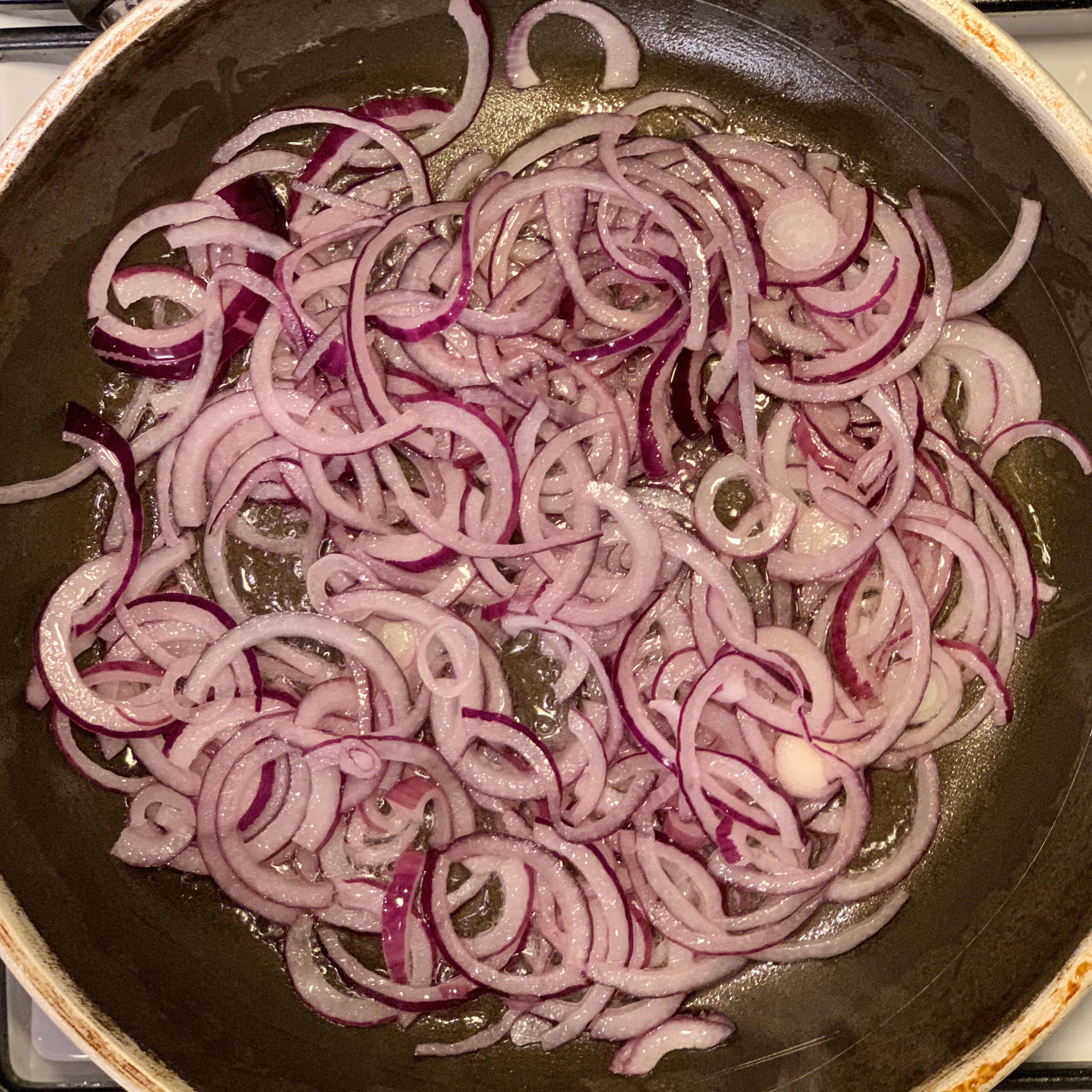 Heat oil in a pan and add the onions. Fry until they turn yellowish.