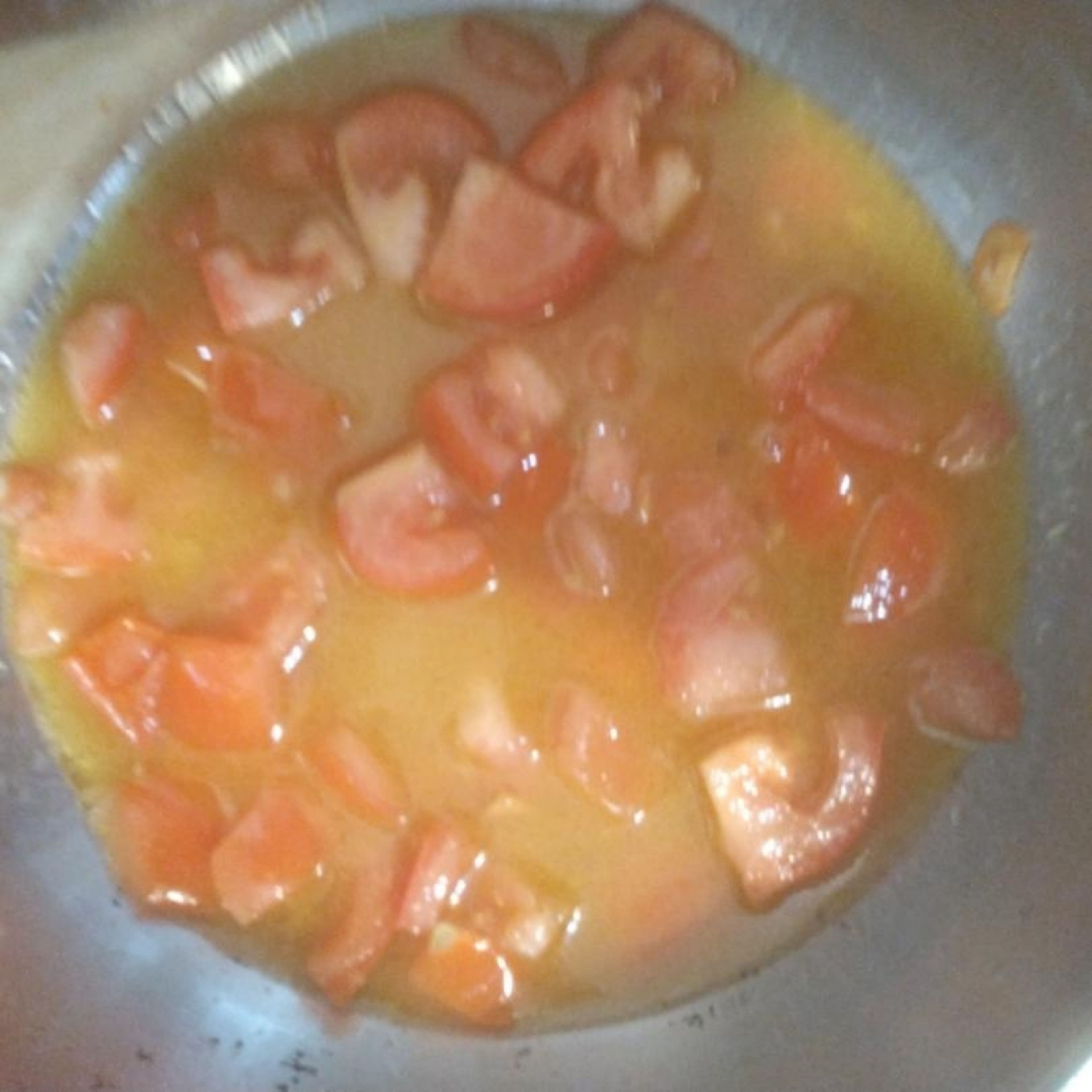 Meanwhile, preheat the oven to gas 9, and place a baking tray in the oven. Get on with sauce. Dice the tomatoes, and roughly slice the garlic. Fry the garlic in a. preheated pan with olive oil for about 2 mins until golden brown over a medium heat. Add the tomatoes, and 2 generous splashes of water, and let simmer until reduced and the tomatoes began to break down. Add some seasoning, garlic granules, and any dried italian herb you have. Blend the sauce - you can have it smooth, chunky or 50/50.