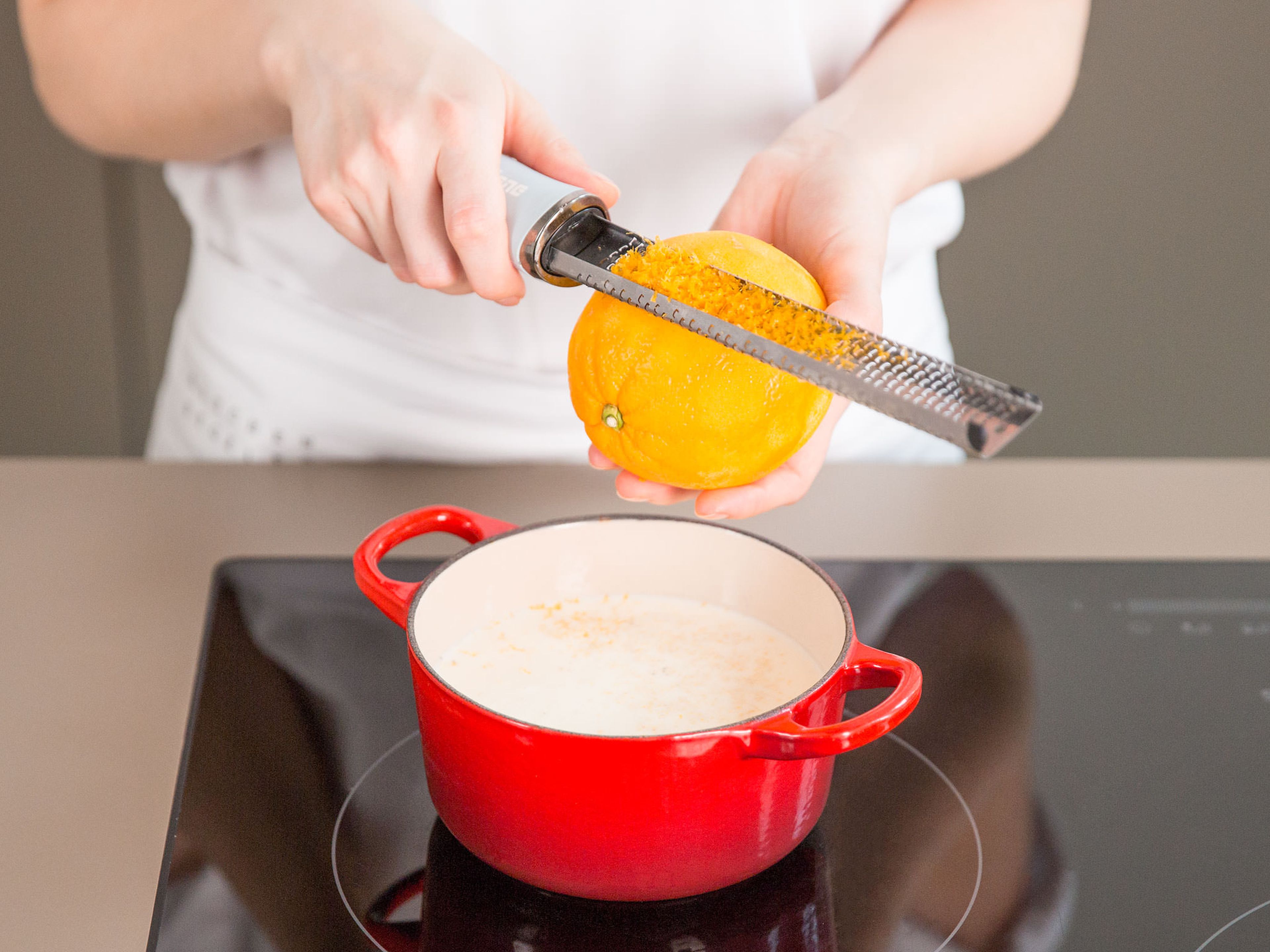 Add the remaining cream, milk, vanilla bean seeds, and orange zest to a small saucepan. Bring to a boil over medium-low heat and then leave it to cool for approx. 5 – 10 min.