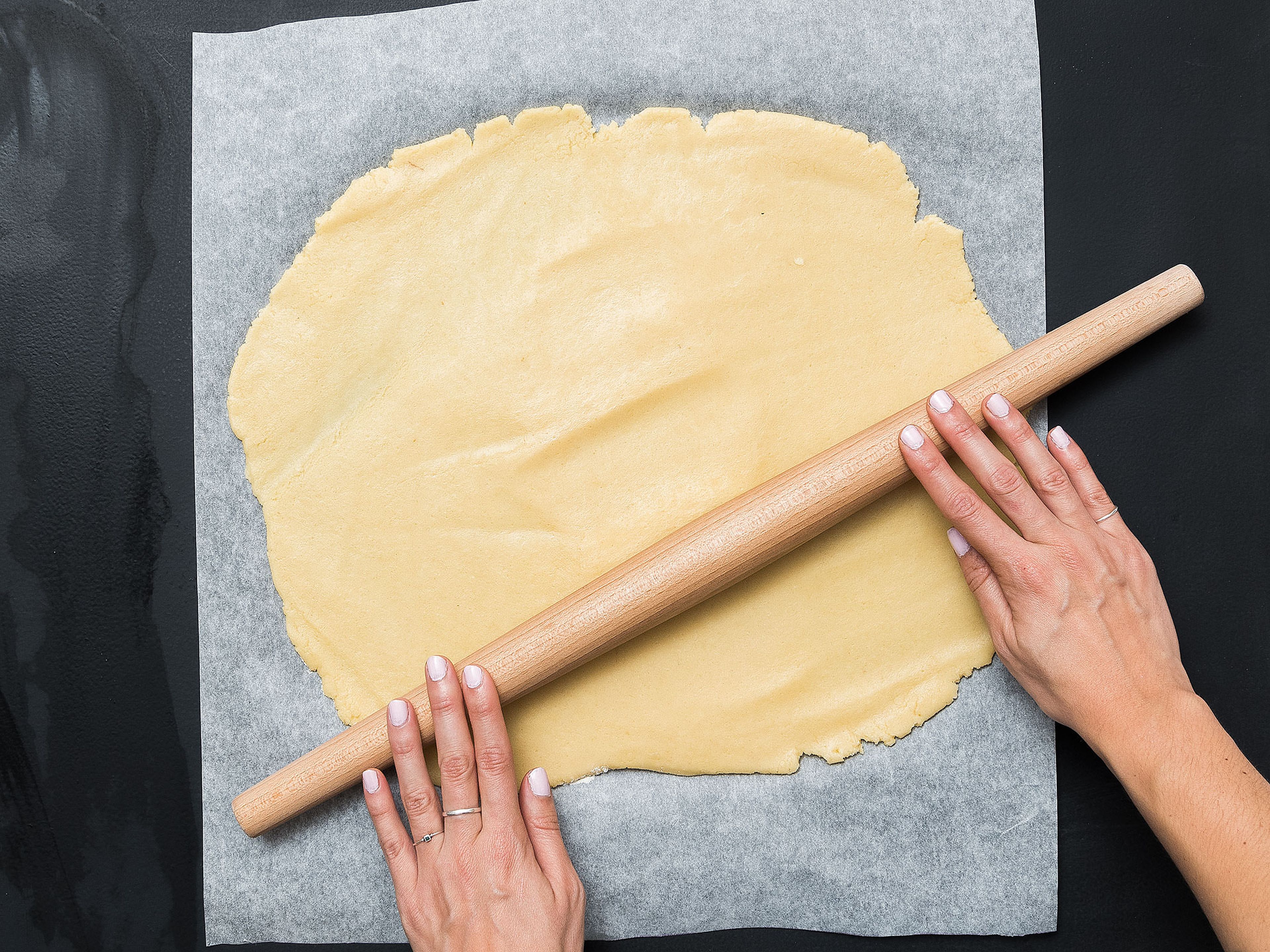 Take the doughs out of the fridge and roll each out separately on parchment paper to approx. 1 cm/ 0.5 in. thick. Place the black dough on top of the white dough and lightly press to seal. Carefully roll into a log to create a spiral. Wrap and transfer to the freezer for approx. 20 – 30 min.