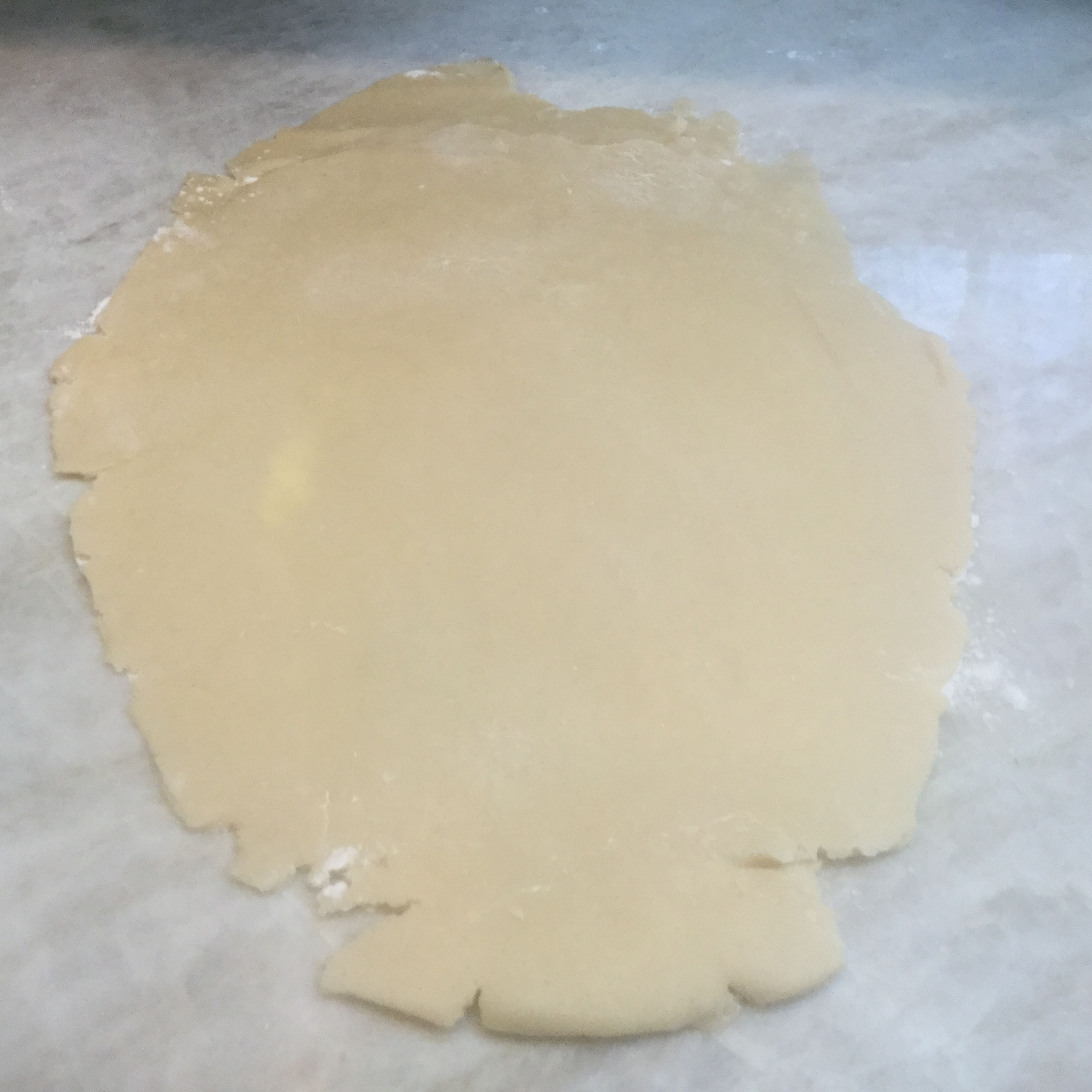 Take one half of the dough out. Sprinkle flour on the counter and roll the dough out. It should be a 1/4 inch thick.
