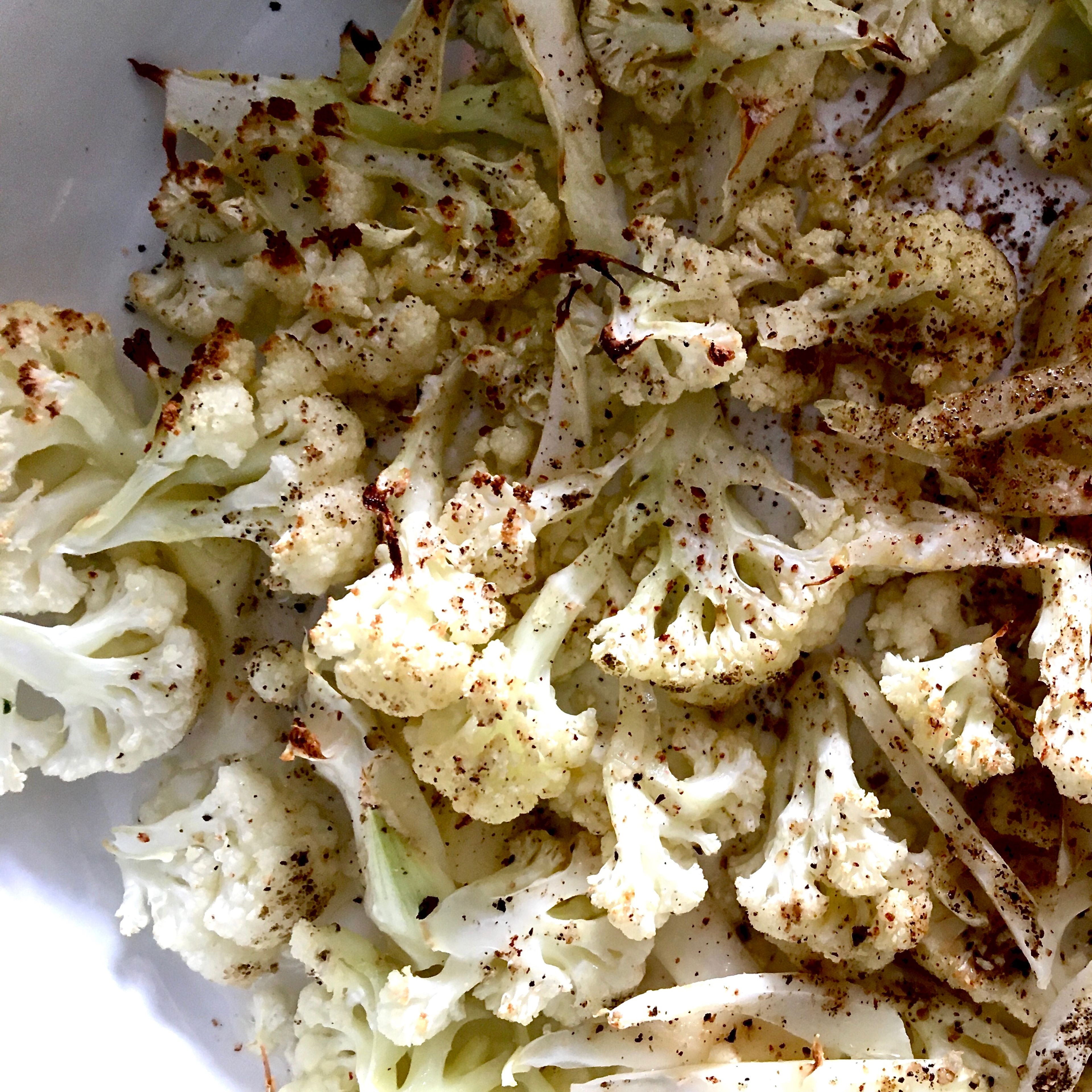 Place cauliflower pieces in an oven-safe dish. Season with half of freshly grated nutmeg, salt and pepper. Drizzle with olive oil and place in the oven until charred. Add in hazelnuts and place back in the oven for some more minutes, until the nuts get a good roast.