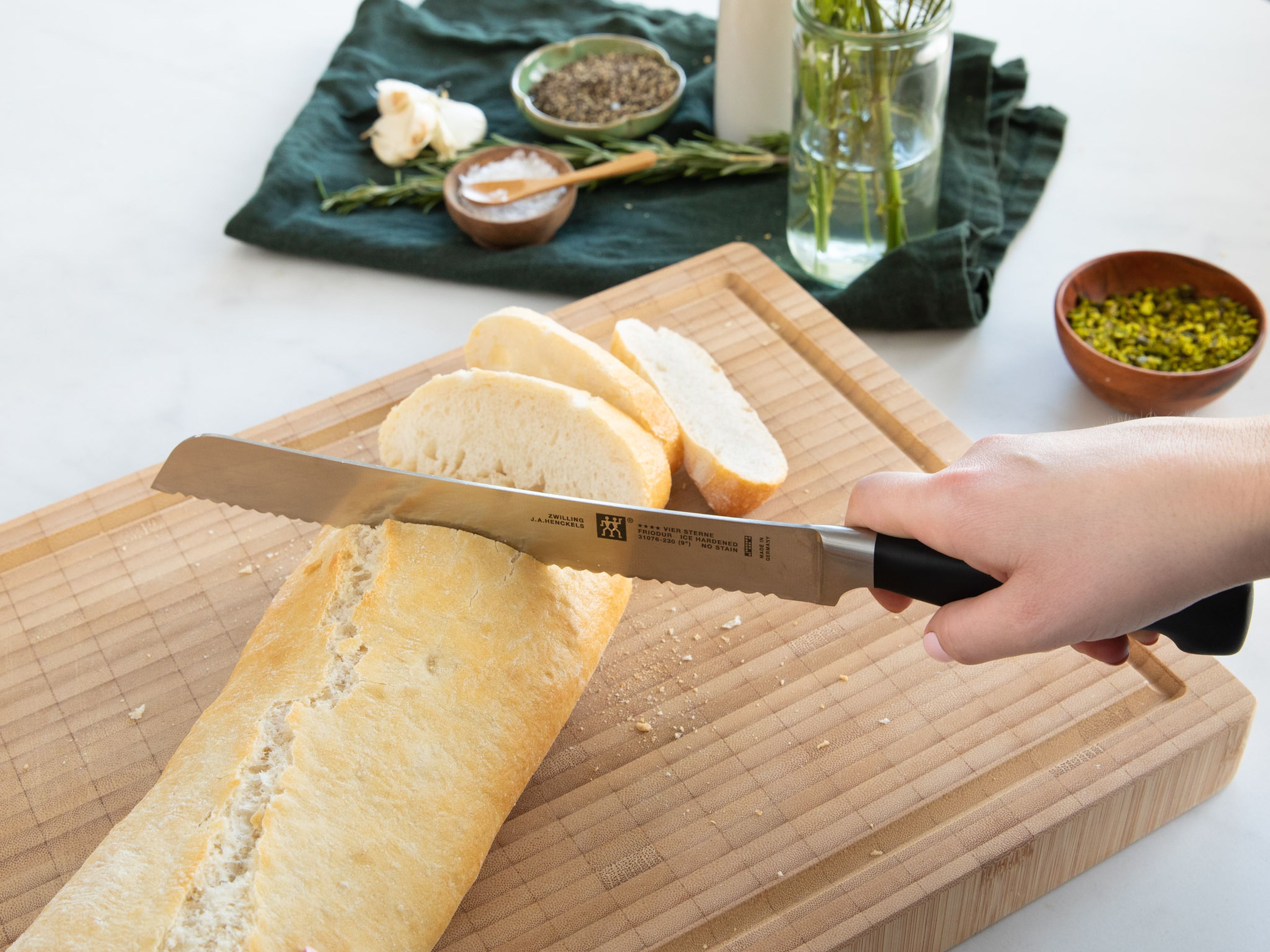 Slice ciabatta, transfer to a baking sheet, and drizzle with remaining olive oil. After the feta cheese has baked for 10 min., transfer the ciabatta to the oven as well. Roast it for the remaining 15 min. This way, the feta cheese and ciabatta will be done around the same time.