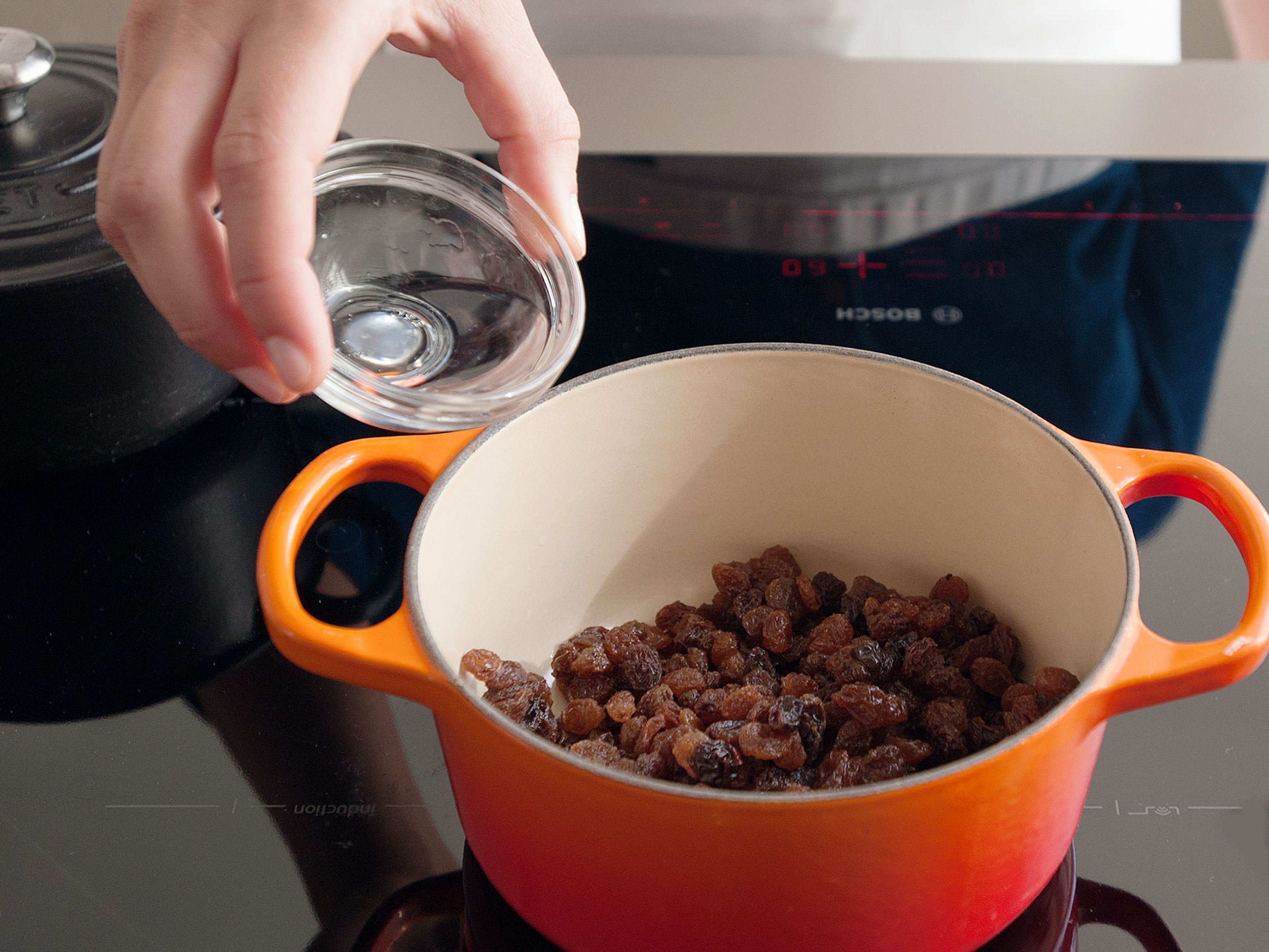 In a small saucepan, combine raisins, rum, and water. Bring to a simmer, stir well, then remove from heat and leave to plump and absorb the liquid as they cool.  Slice candied orange peel and split and scrape the vanilla bean; set aside.