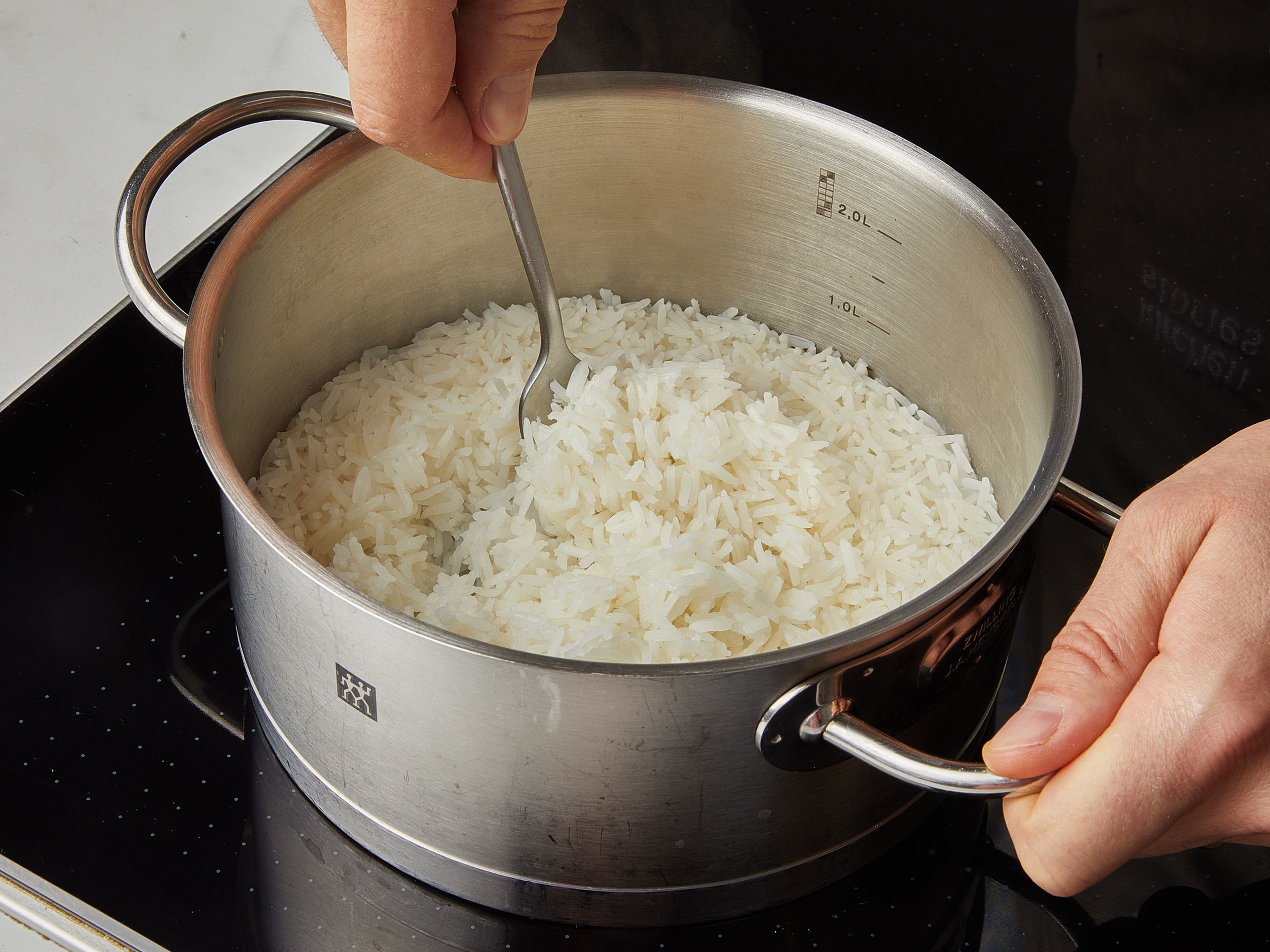 Wenn die Eier fertig sind, den Jasminreis unter Wasser abspülen, bis das Wasser klar ist. Dann in einen Topf mit Deckel geben. Wasser hinzufügen, abdecken und zum Kochen bringen. Sobald der Reis kocht, die Hitze auf niedrige Stufe reduzieren und ca. 10 Min. kochen. Dann den Herd ausschalten und weitere ca. 5 Min. dämpfen lassen. Je 2 Eier auf eine Schüssel gekochten Reis geben und ca. 2 EL Marinade als Soße über den Reis schöpfen. Mit geröstetem Sesam und Frühlingszwiebeln garnieren.
