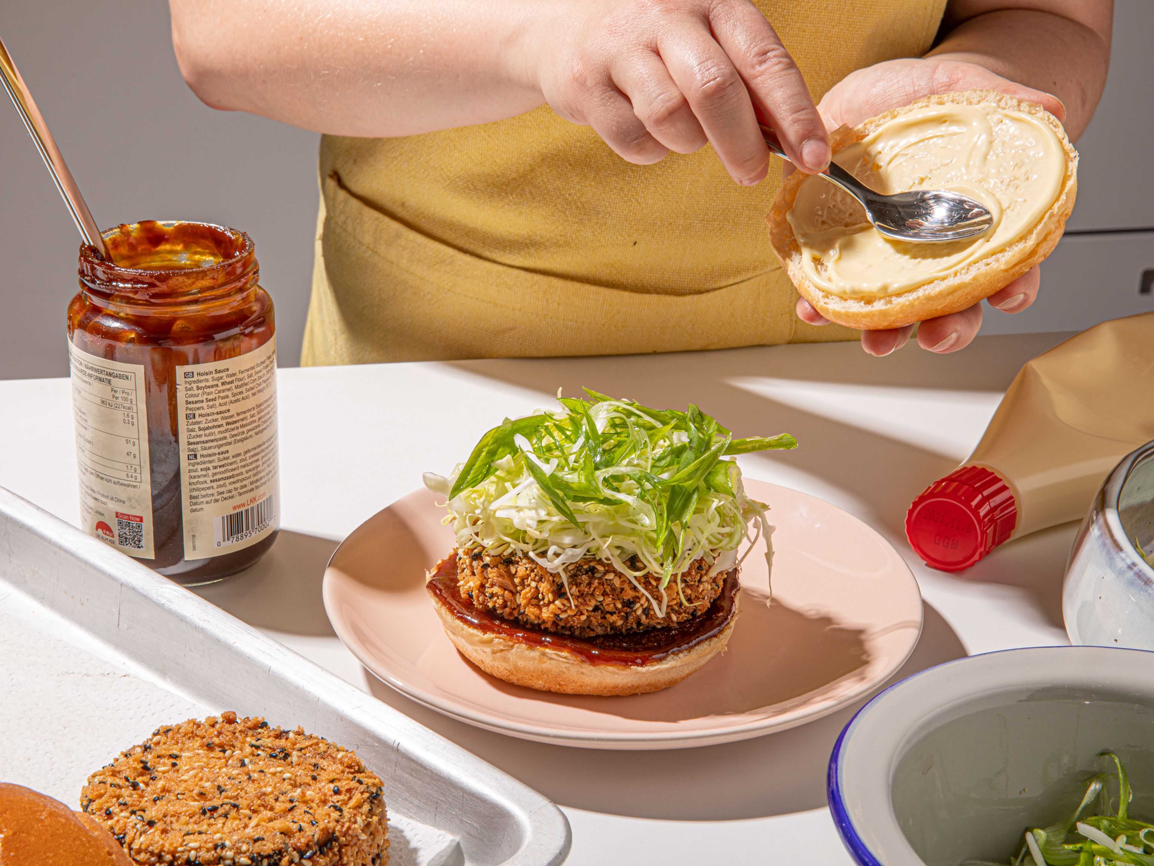 To serve, first toss the shredded cabbage with the rice vinegar and season with salt. Spread a thin layer of hoisin sauce on the base burger bun, top with the eggplant katsu patty, and add cabbage and spring onions on top. Spread kewpie mayo onto the burger lid, close the burger, and enjoy immediately!