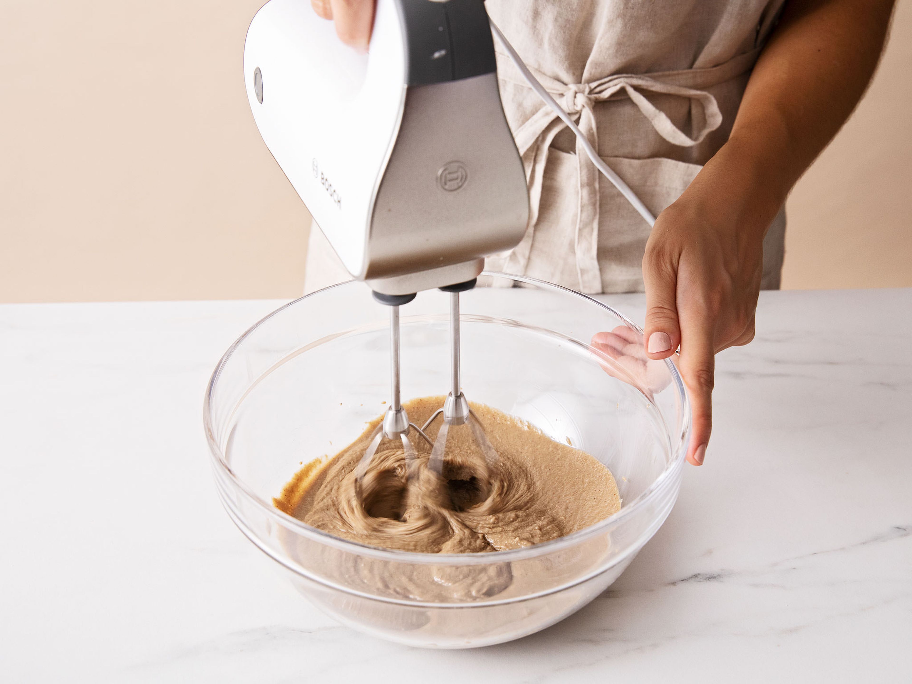 Add tahini and salt to a bowl and beat with a hand mixer with beaters on medium speed. Carefully pour bubbling sugar mixture into the tahini. Mix until it’s fully incorporated and fudgy, approx. 20 seconds. Do not overmix!