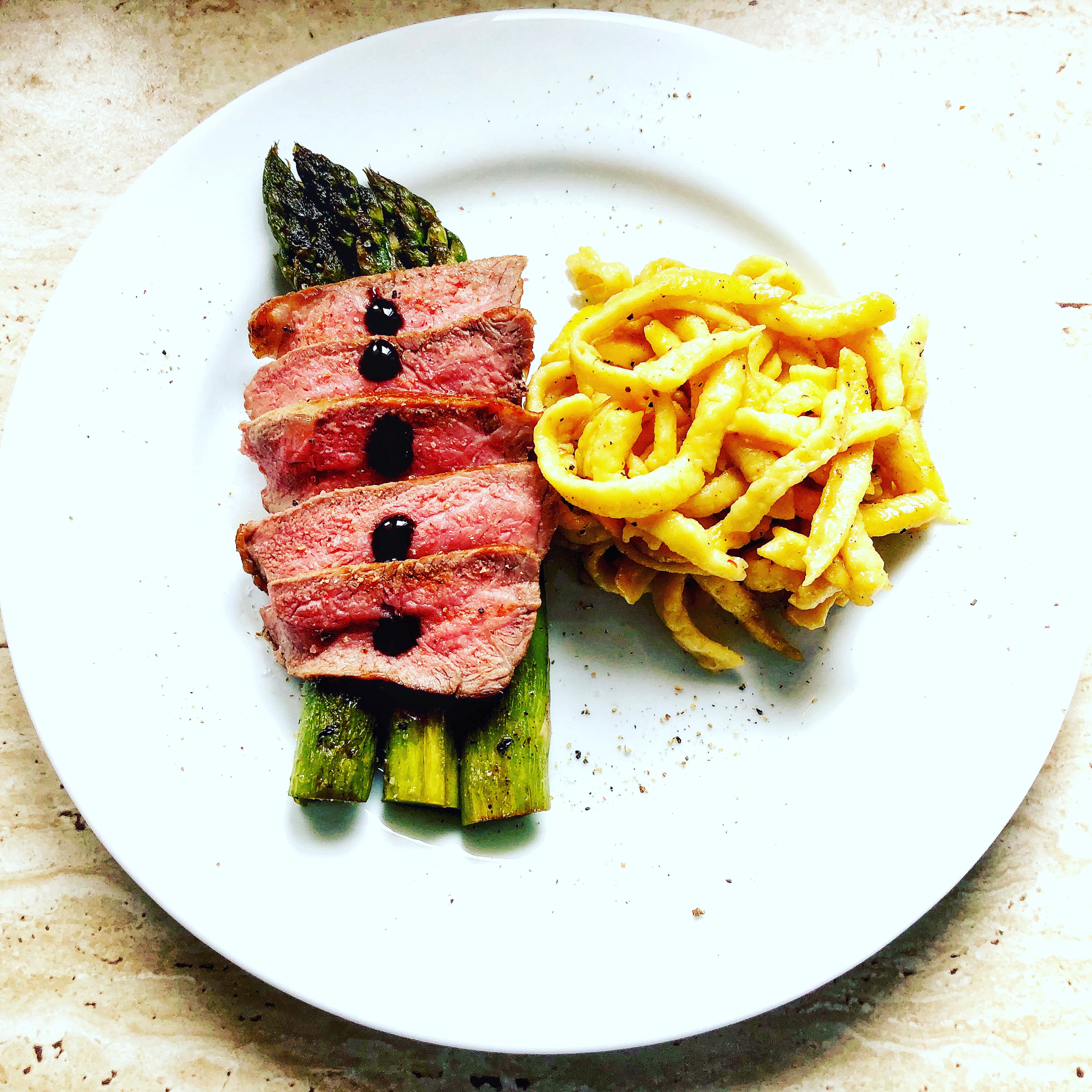 Steak with spätzle and asparagus