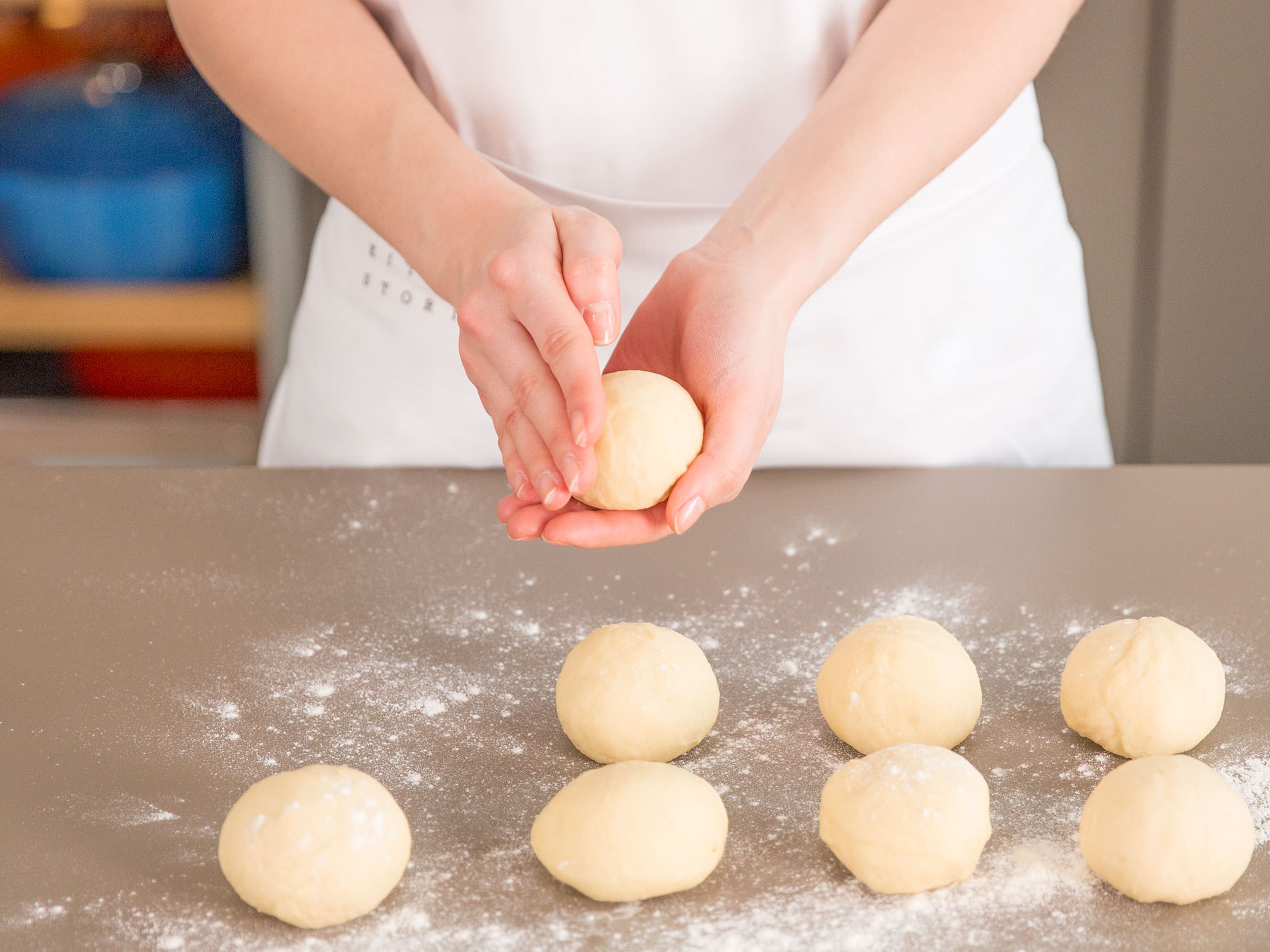 Turn out dough onto a floured work surface, cut in half, and then cut halves into pieces approx. the size of a small closed fist. Knead each piece by hand into small rounds. Cover and let rise for another 30 min.