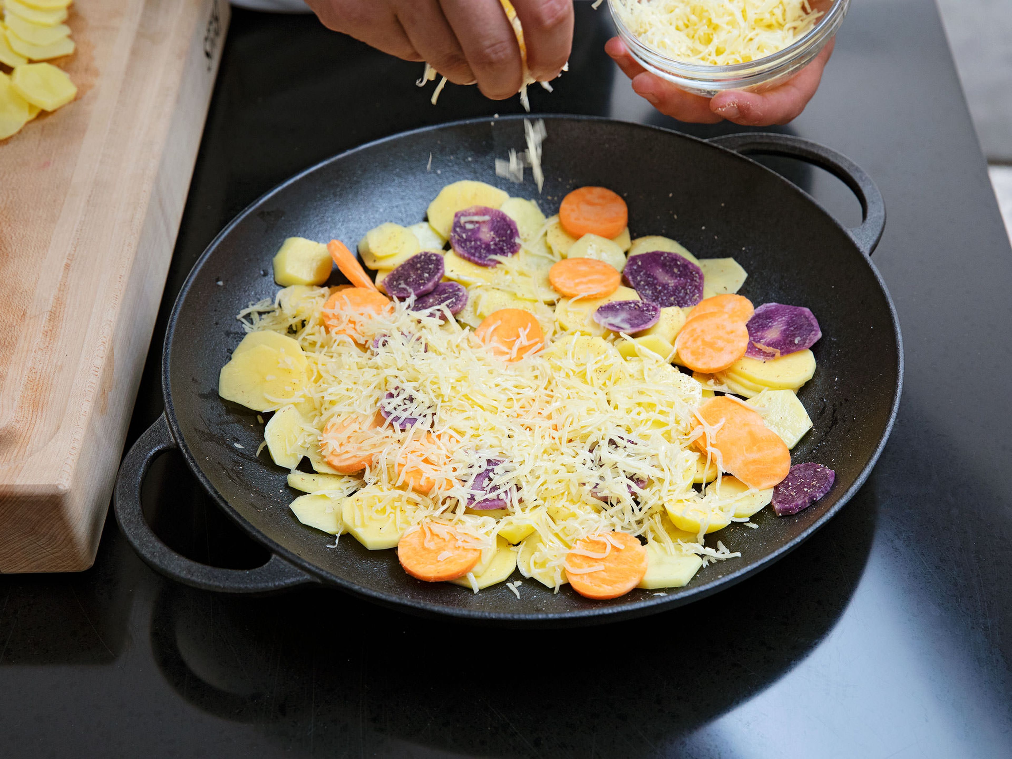 Evenly layer half of the potatoes a microwave-safe baking dish. Season with salt and pepper. Sprinkle with three quarters of the shredded Emmentaler cheese. Then, layer the remaining potatoes, alternating yellow, purple, and sweet potatoes. Sprinkle remaining cheese on top.
