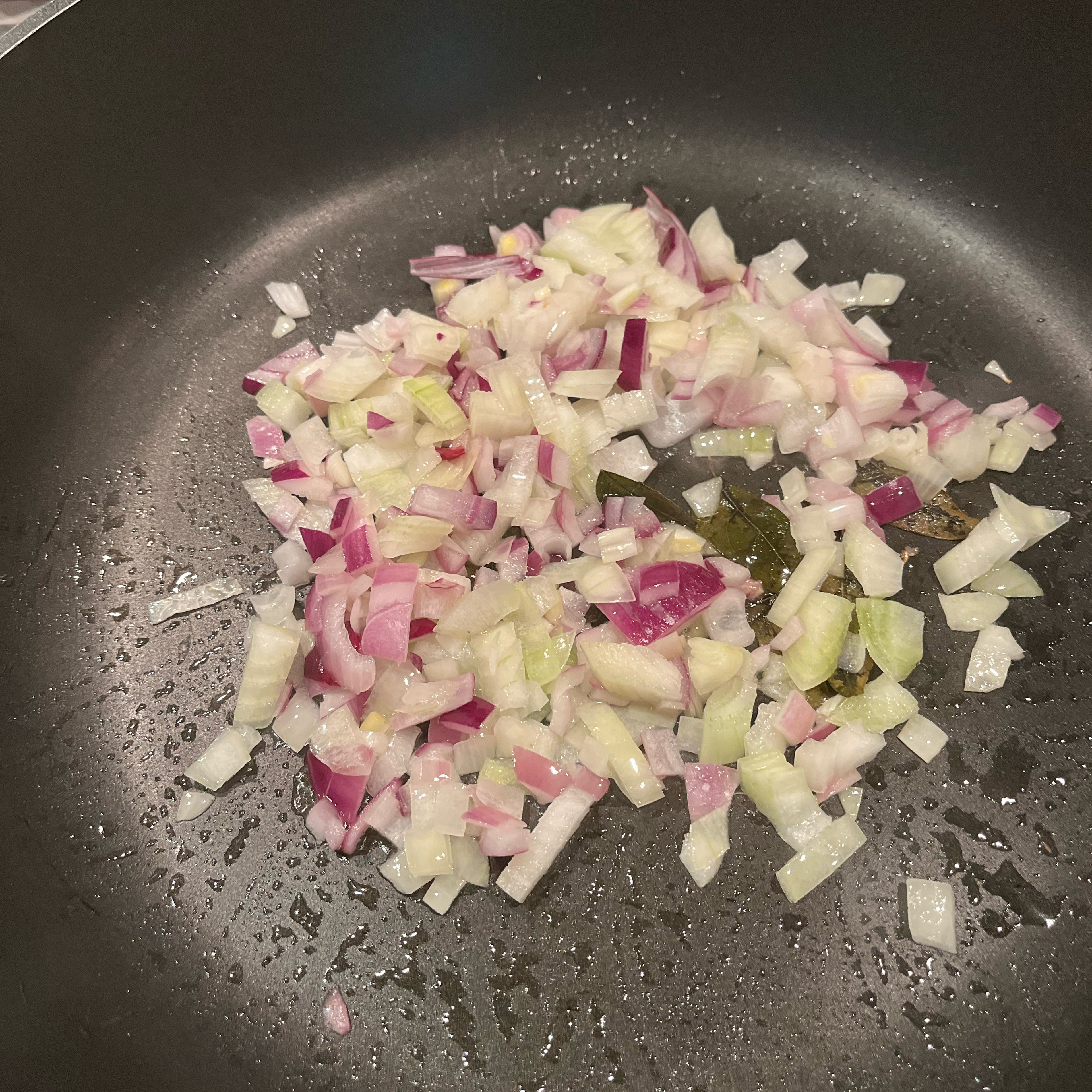 Heat oil in a pan, add curry leaves and onions and fry till golden brown.
