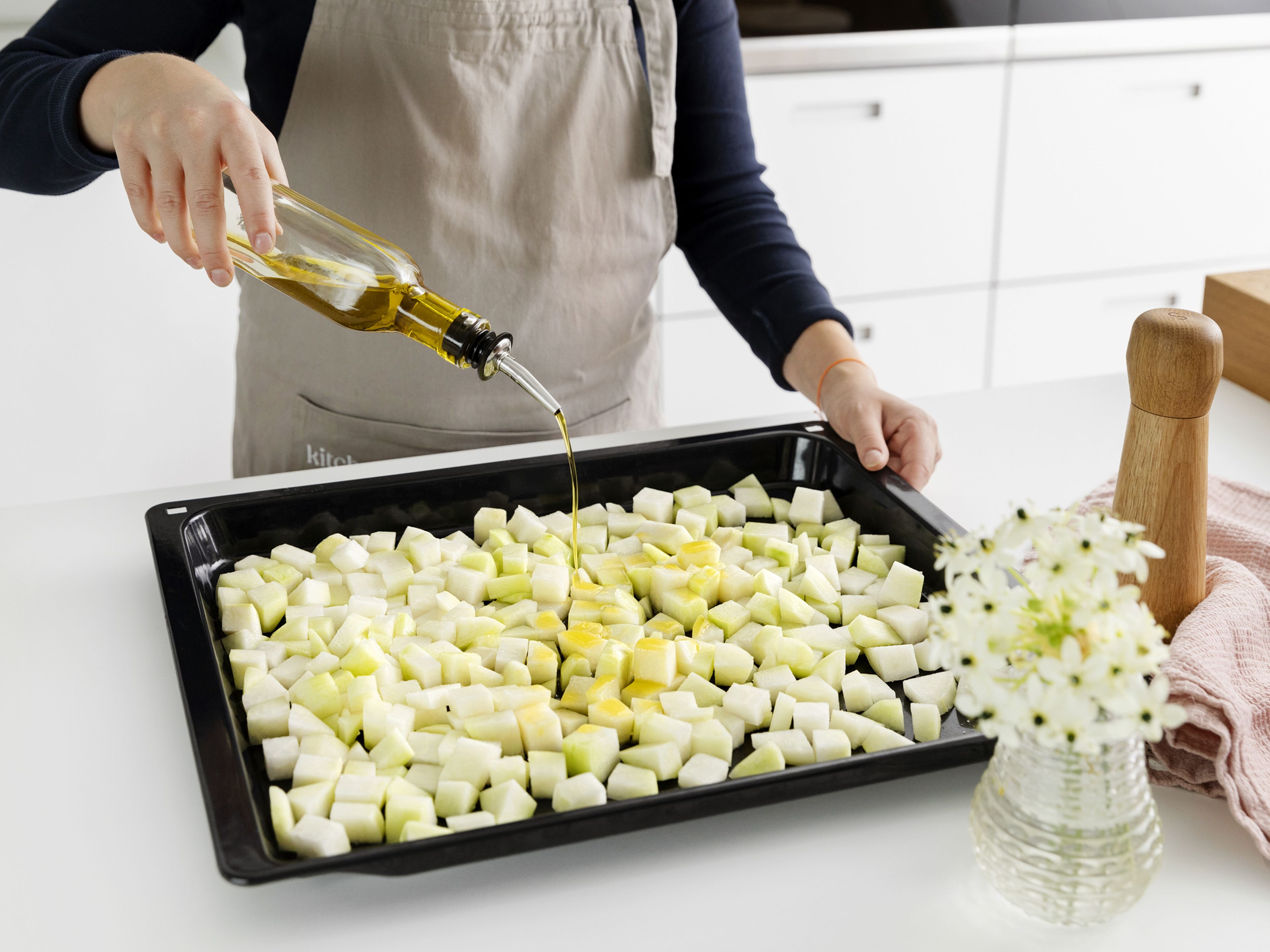 Preheat the oven to 200°C/390°F.  Zest orange and set aside for garnishing. Juice the orange. Dice onion and mince garlic. Peel and chop kohlrabi into 2-cm/0.5-in cubes. Transfer kohlrabi to a baking sheet and toss with half the olive oil, salt, and pepper. Let roast for approx. 12 min., or until well browned.