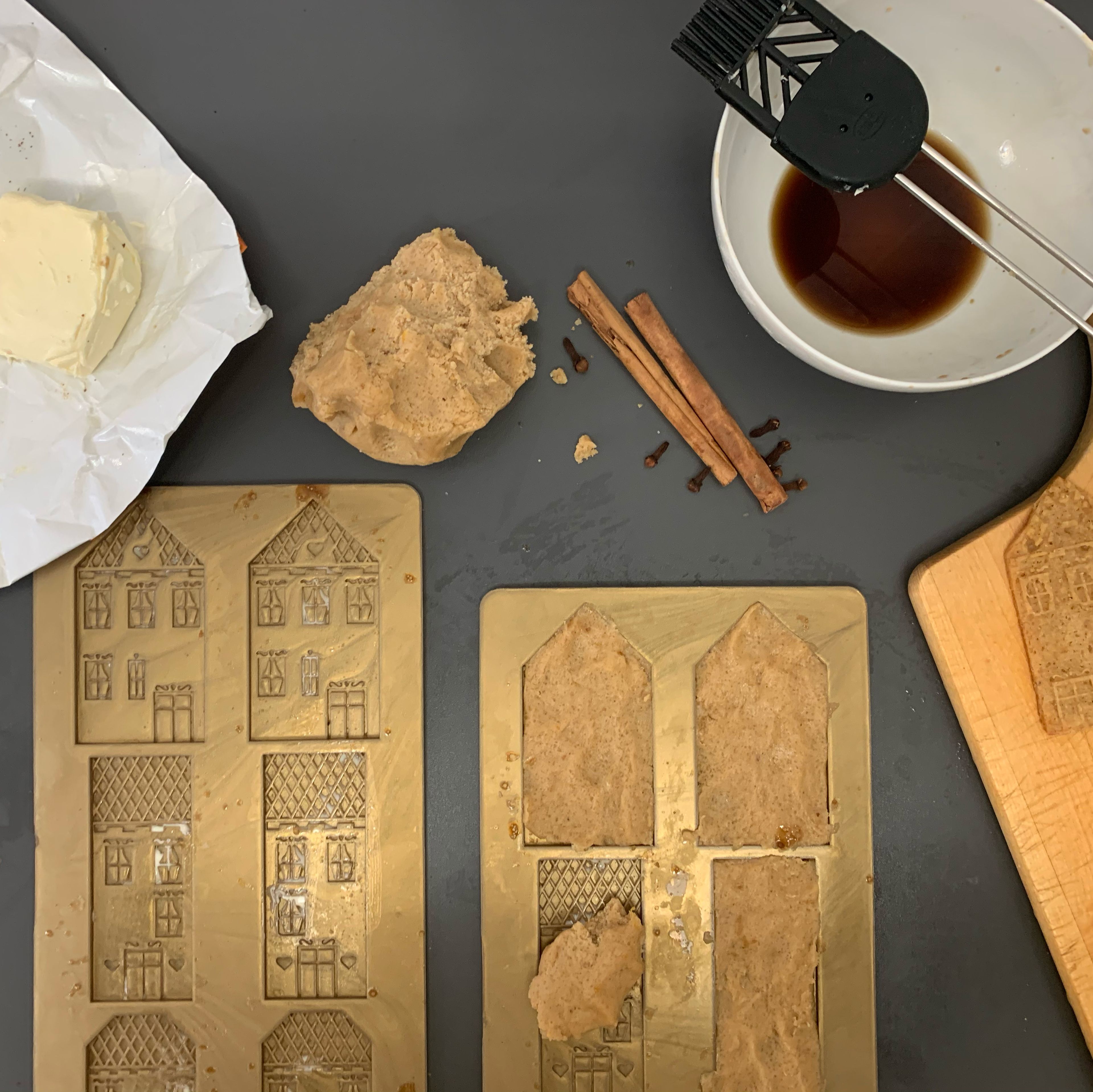 Grease speculaas mould and press the dough in. Brush with sugared water before placing on a lined baking sheet.