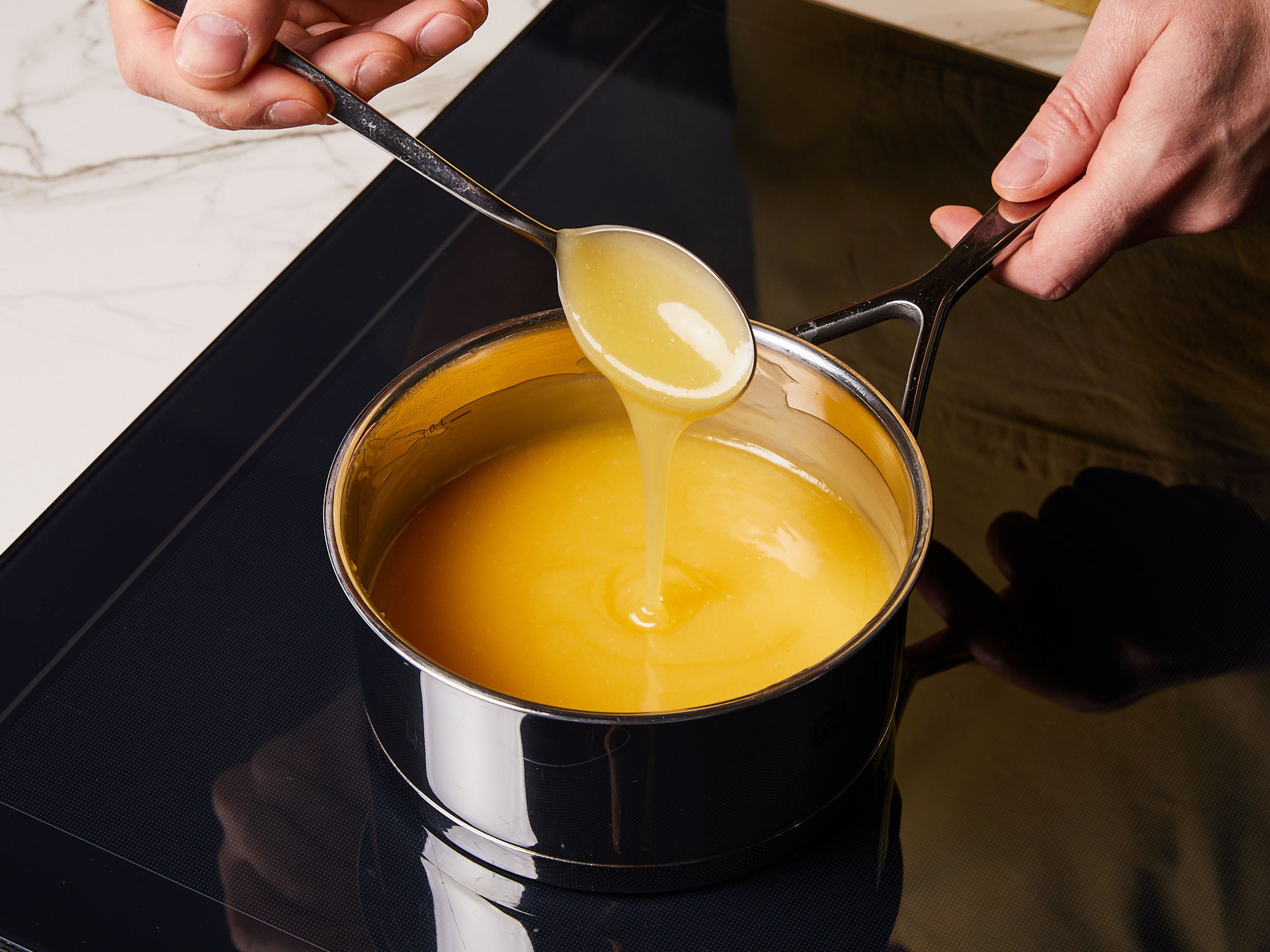 For the lemon curd, in the same saucepan, mix lemon juice, cornflour, sugar, water, butter, limoncello, and egg yolks. Bring to a boil while stirring constantly until thick in consistency for approx. 2 min. Then, remove from heat, cover, and set aside.