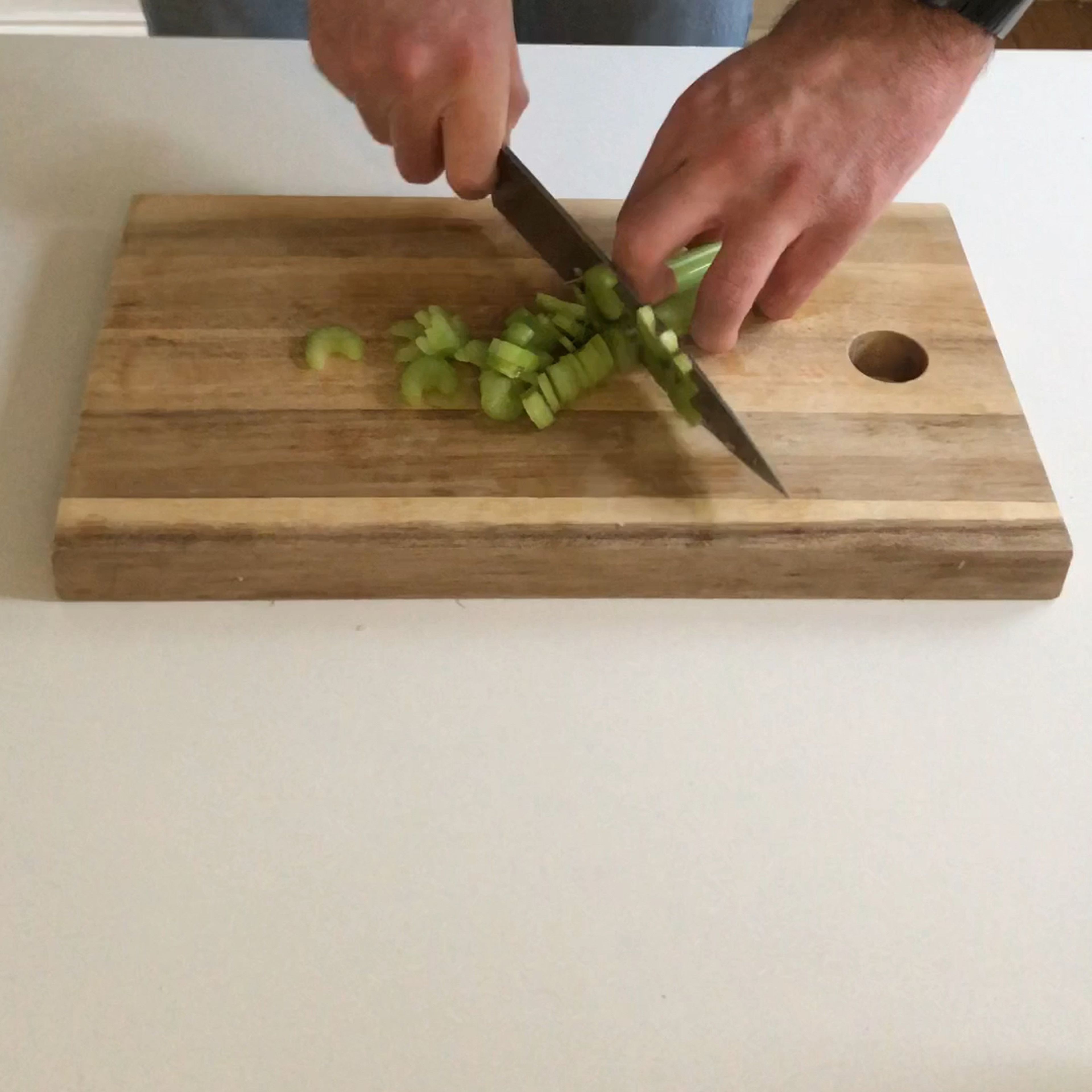 Finely chop onions, celery, carrots and the garlic, in order to prepare the Italian “soffritto”