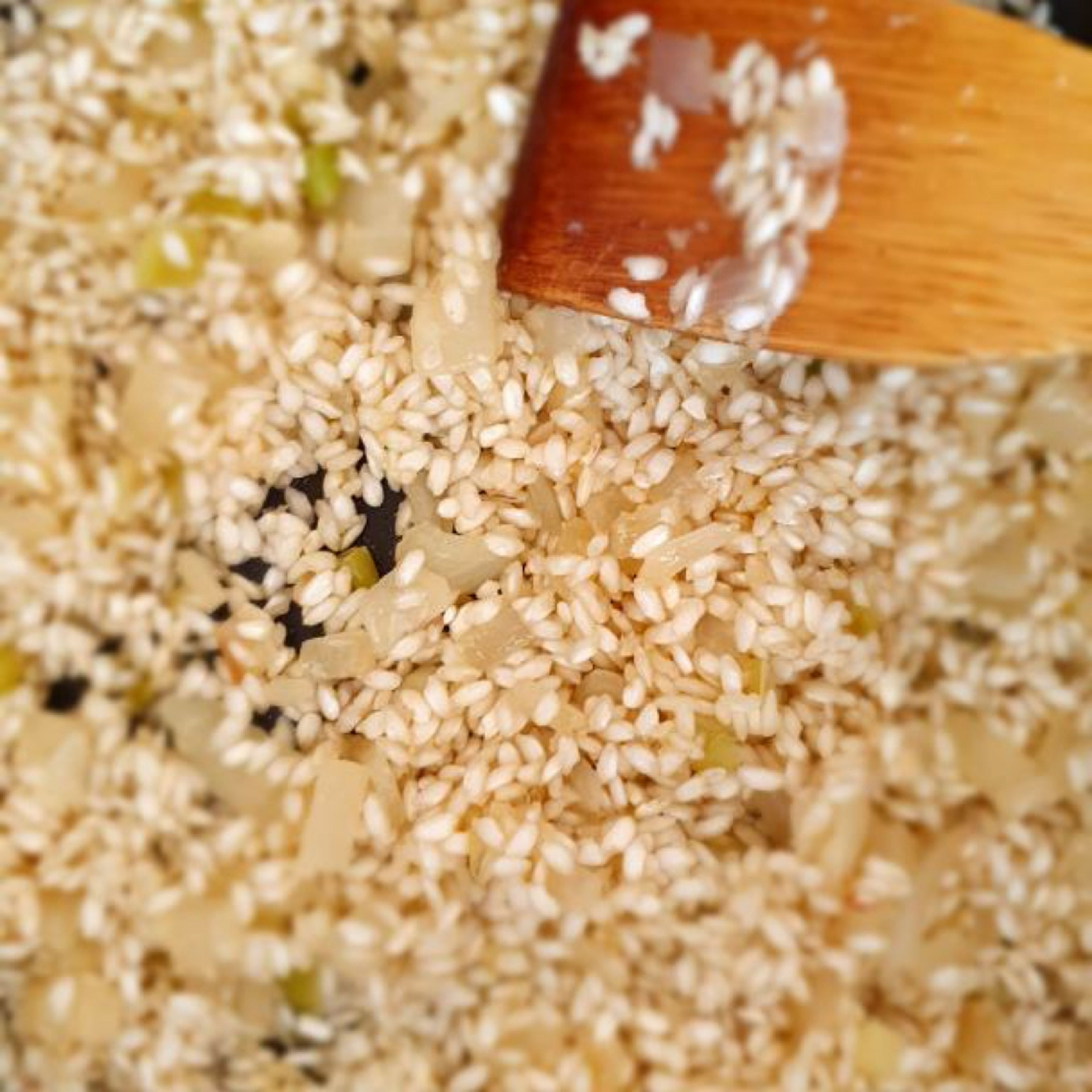 Add the rice and cook for about a minute until it begins to turn slightly translucent. Stir often, coating the rice.