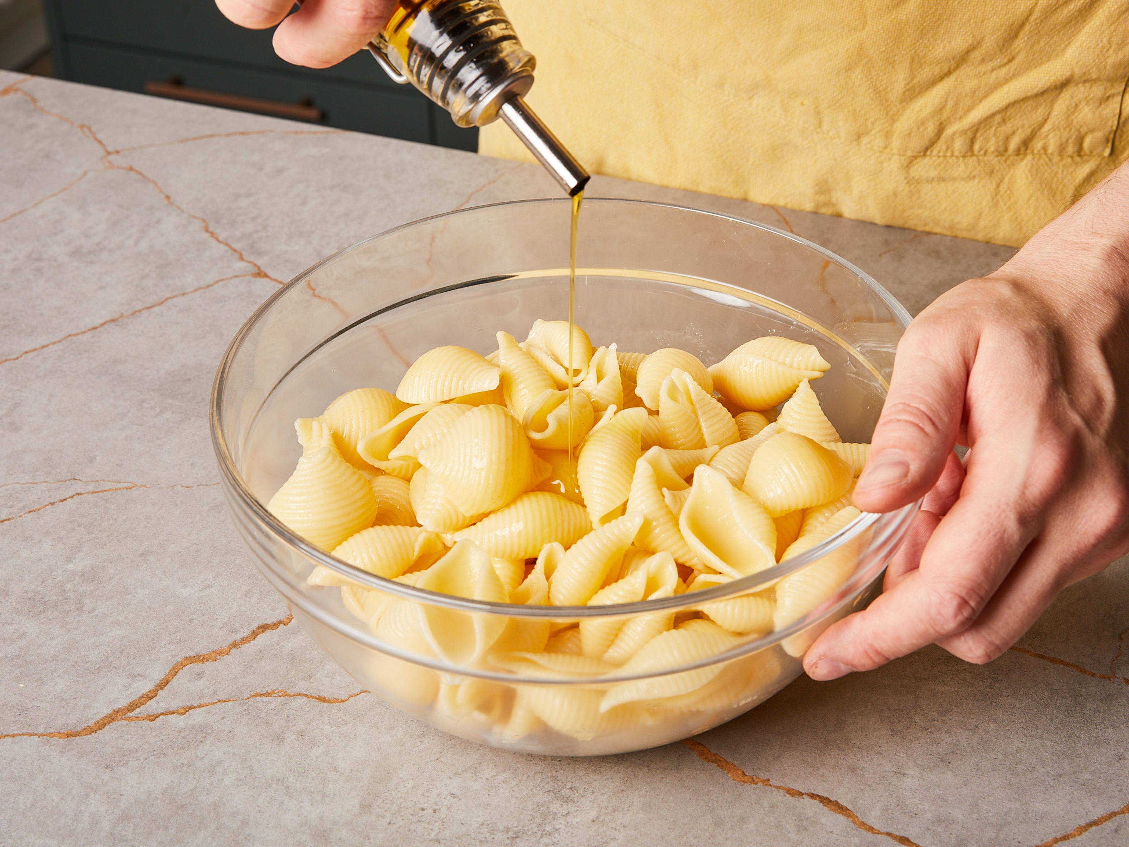 Bring a large pot of generously salted water to a boil. Add pasta and cook according to package directions. At the end of the cooking time, drain pasta. Place pasta in a large bowl and mix with a little olive oil to prevent it sticking together. Set aside to cool.