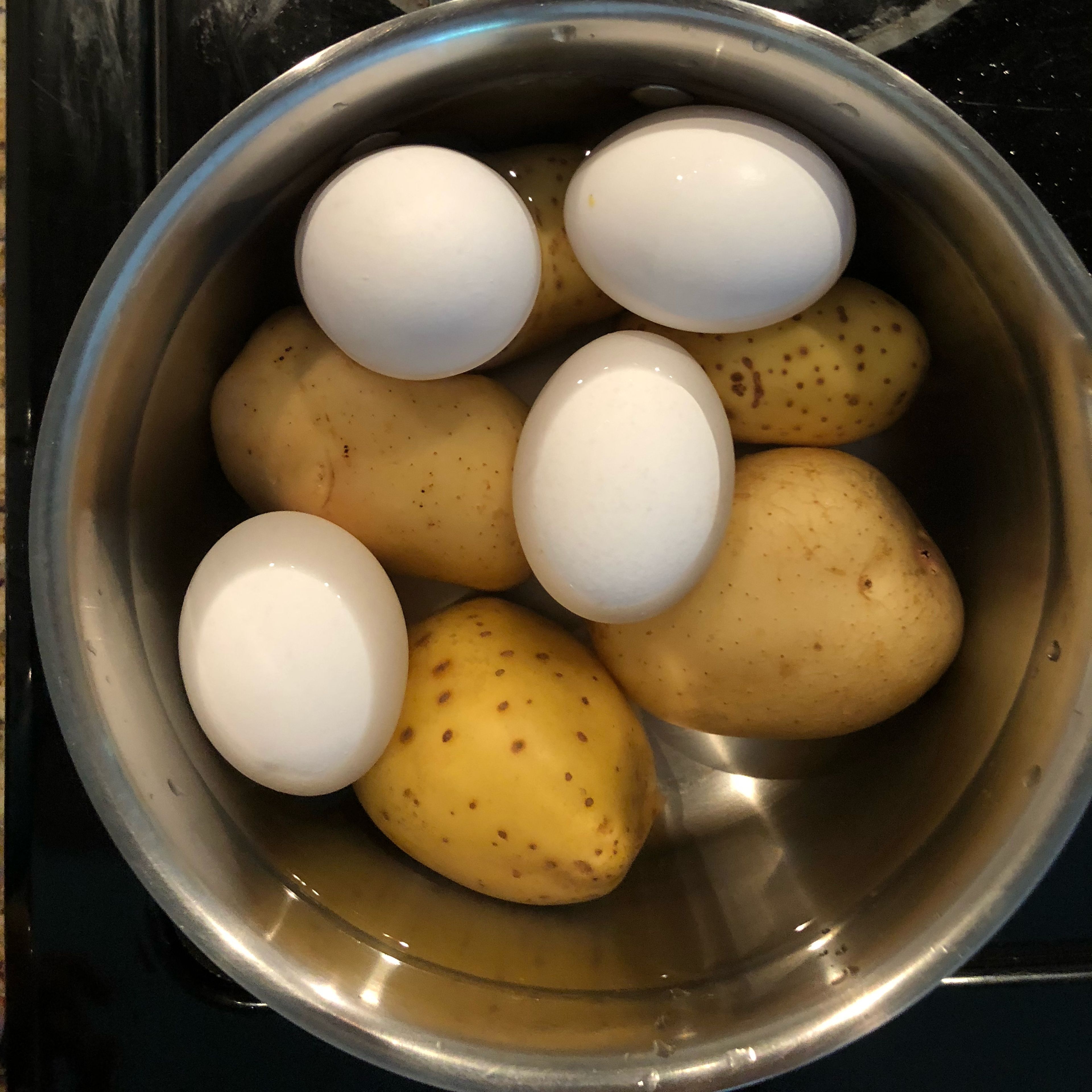Put potatoes and eggs together in a pot of water and then turn on to boil. Boil potatoes until soft for about an hour and eggs for 30mins. (Boil time includes the time it takes for water to start boiling). After done boiling let me them cool for 30 minutesand peel potatoes. Peel eggs under cold water.
