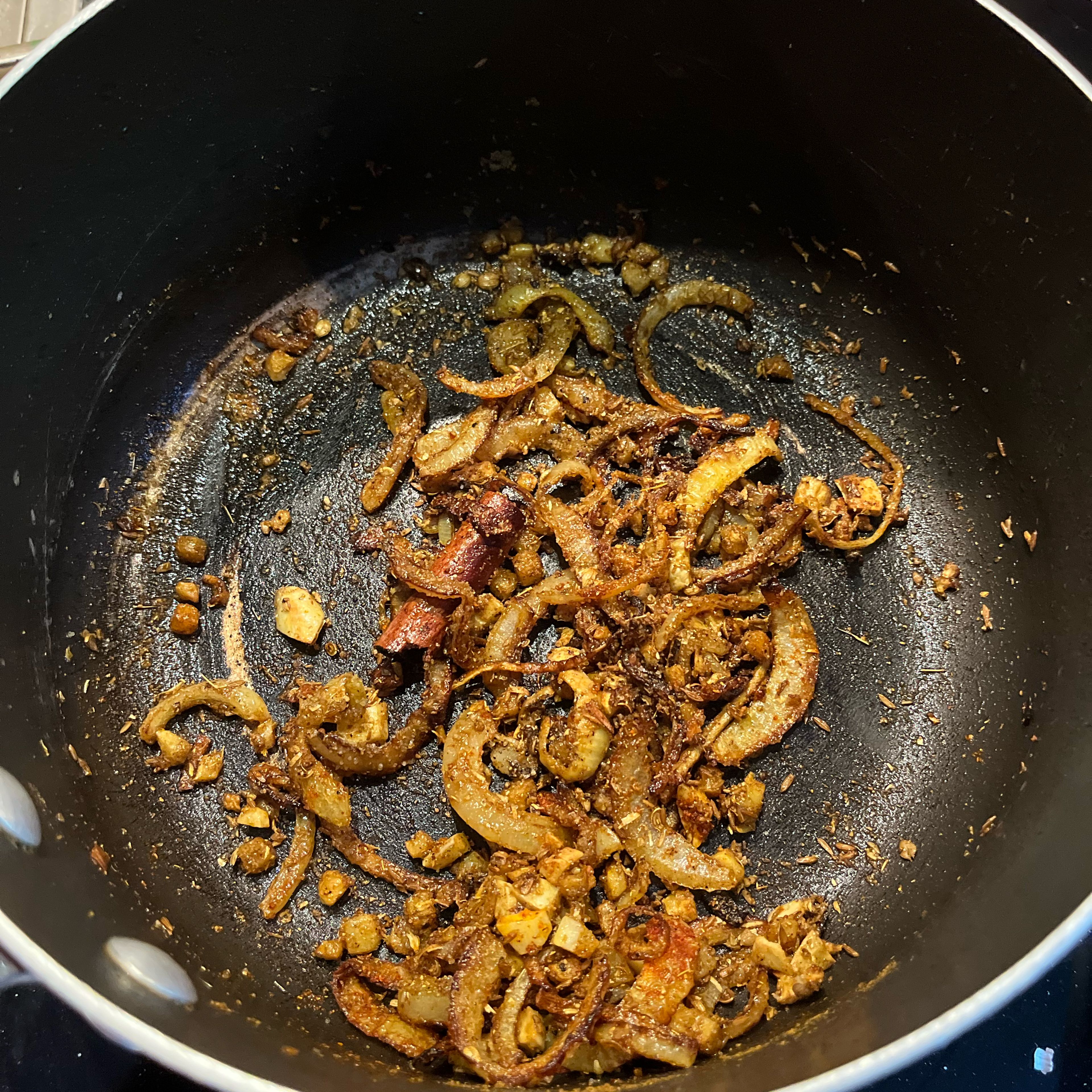Turn down heat to medium, add ginger and garlic and fry until fragrant, then add spices and stir.