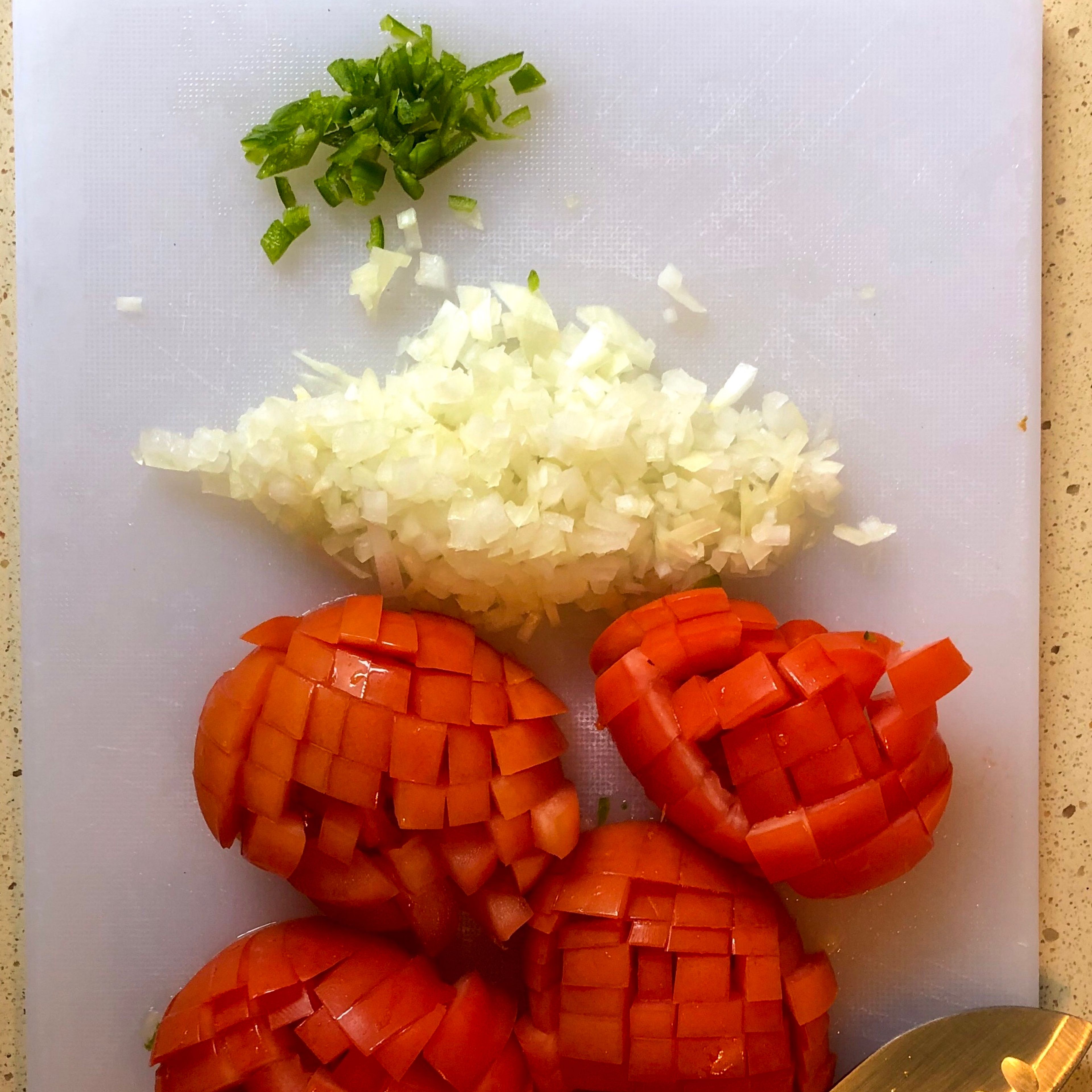Step one: rinse your tomatoes and jalapeño. When dry, we will cut and prep our ingredients. Cut your tomatoes into cubes, mince onion & jalapeño, dice your ham.