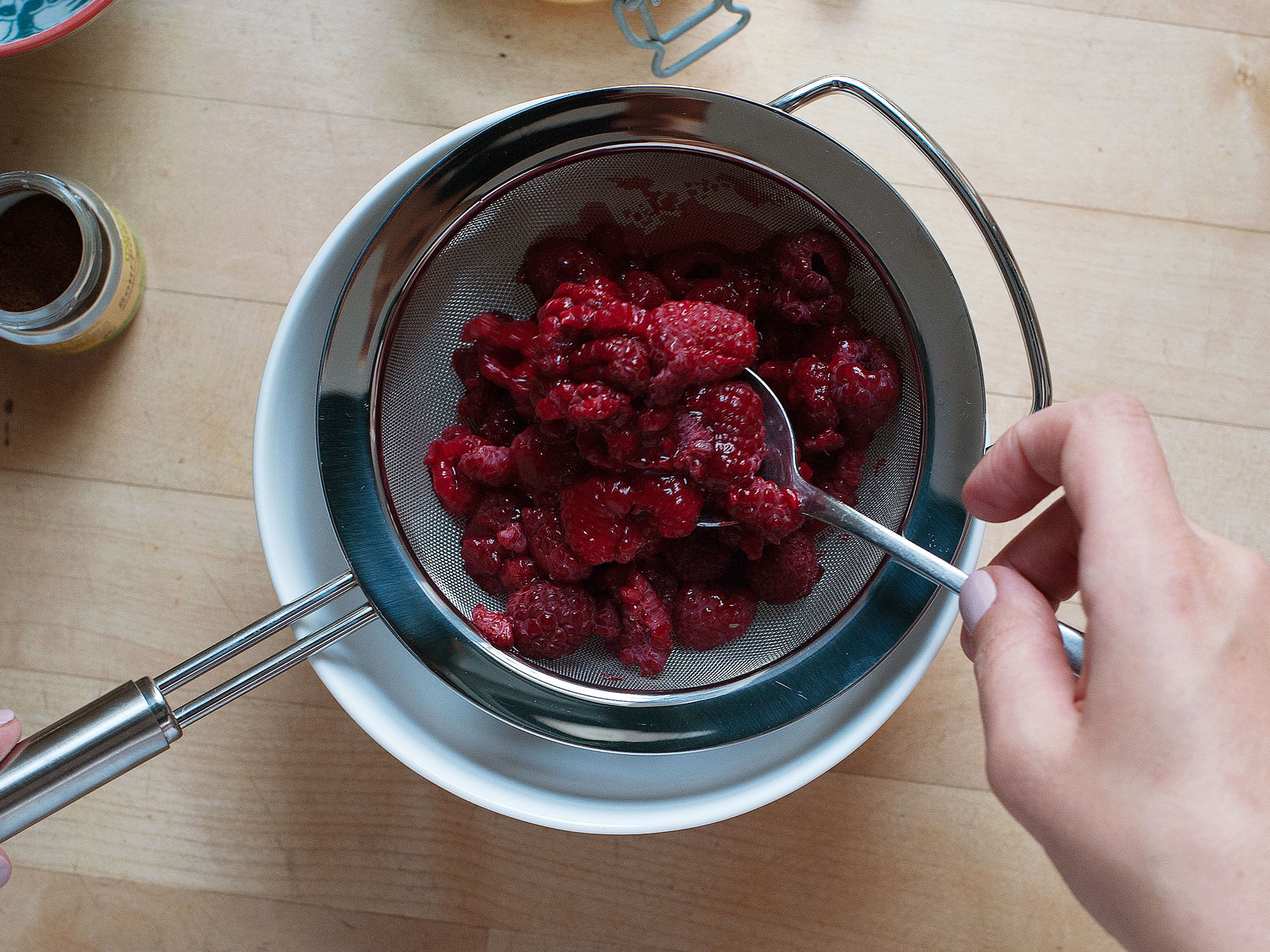 Defrost frozen raspberries, if using. Deseed raspberries by pushing them through a sieve into a mixing bowl.