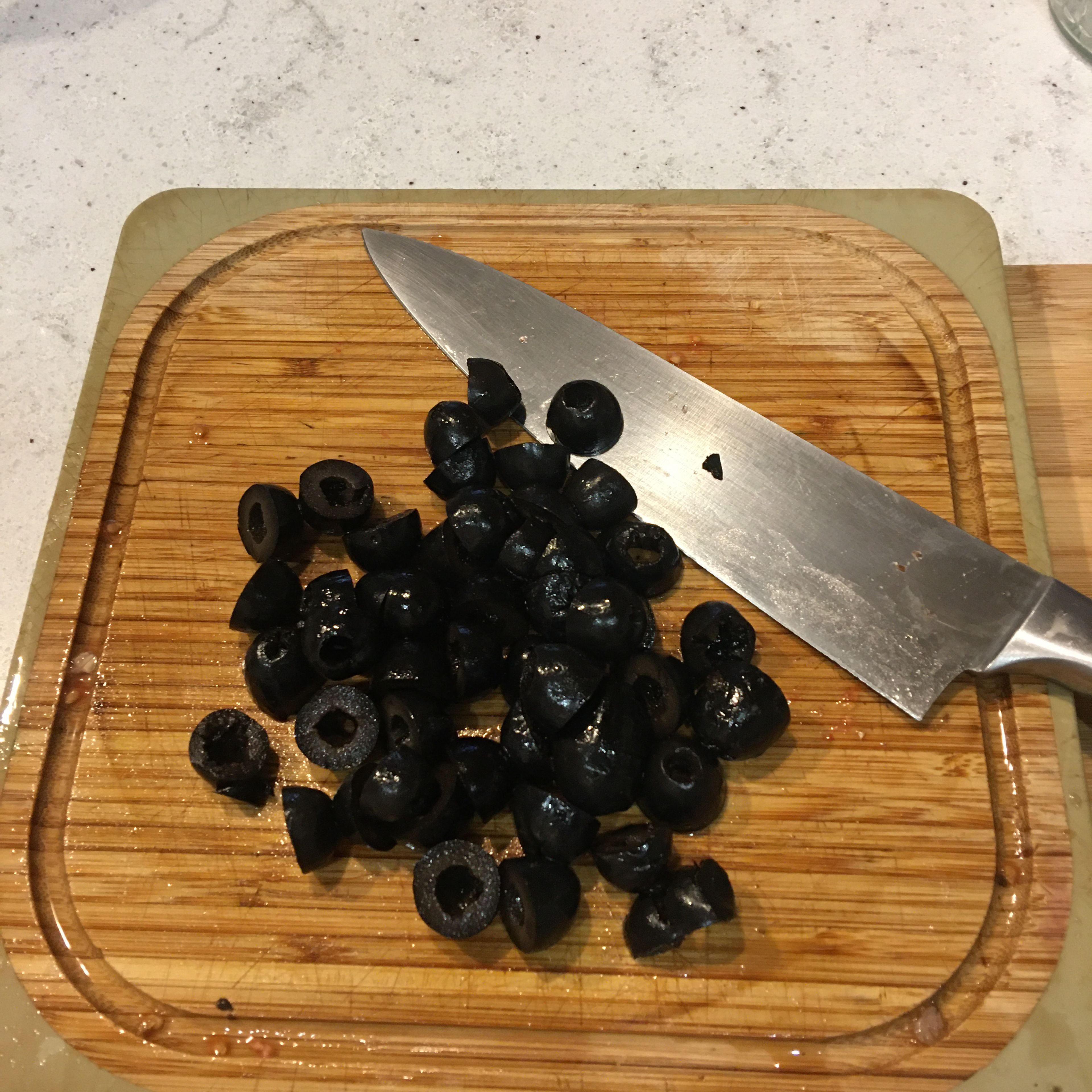 Pit you olives (if they are not pitted) the cut them in half.