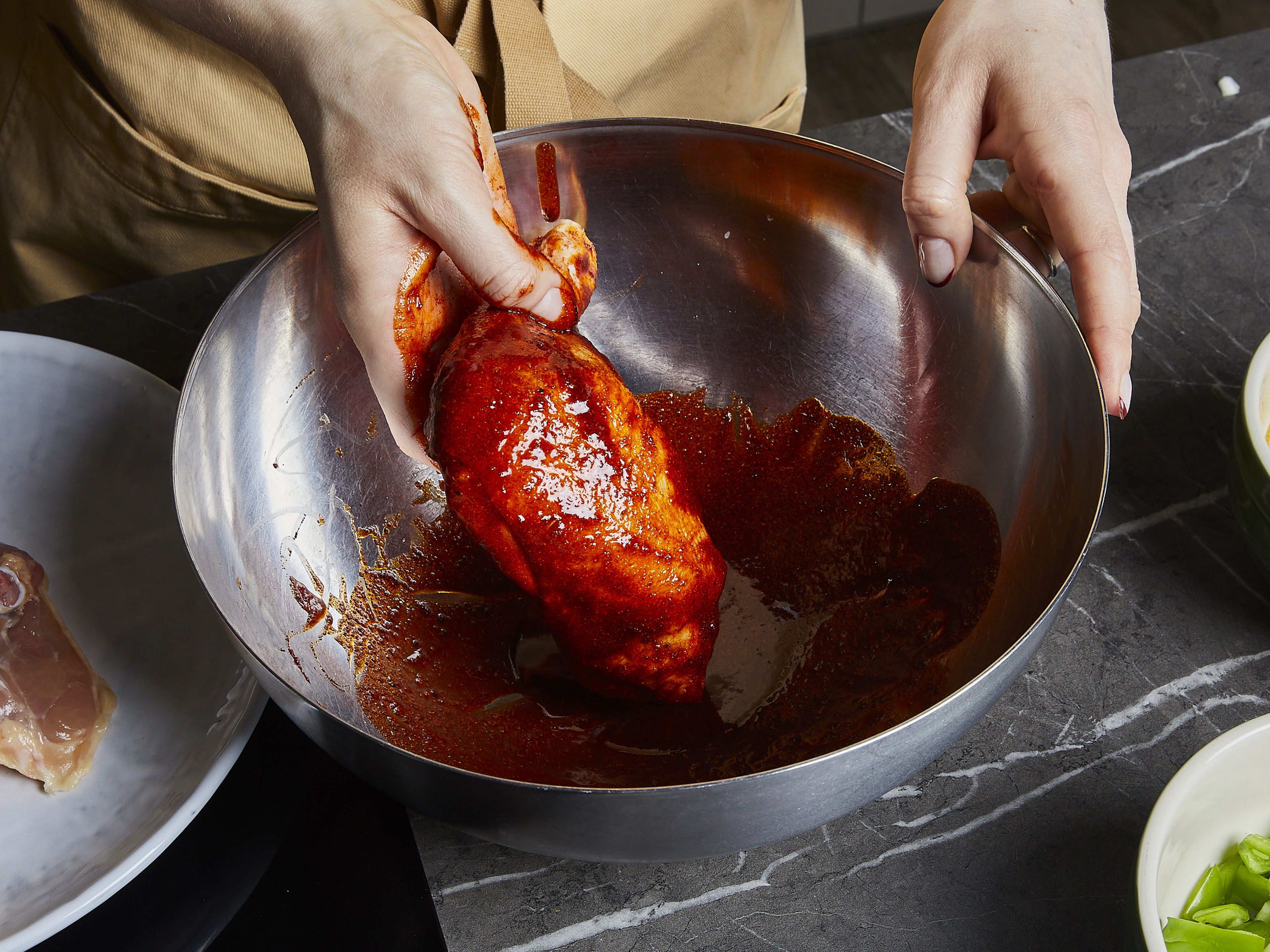 Combine ¾ of the olive oil, a heavy pinch of salt, pepper, ½ of the paprika powder, and garlic powder to make the marinade in a large bowl. Then add the chicken legs to the bowl to rub the marinade in well.