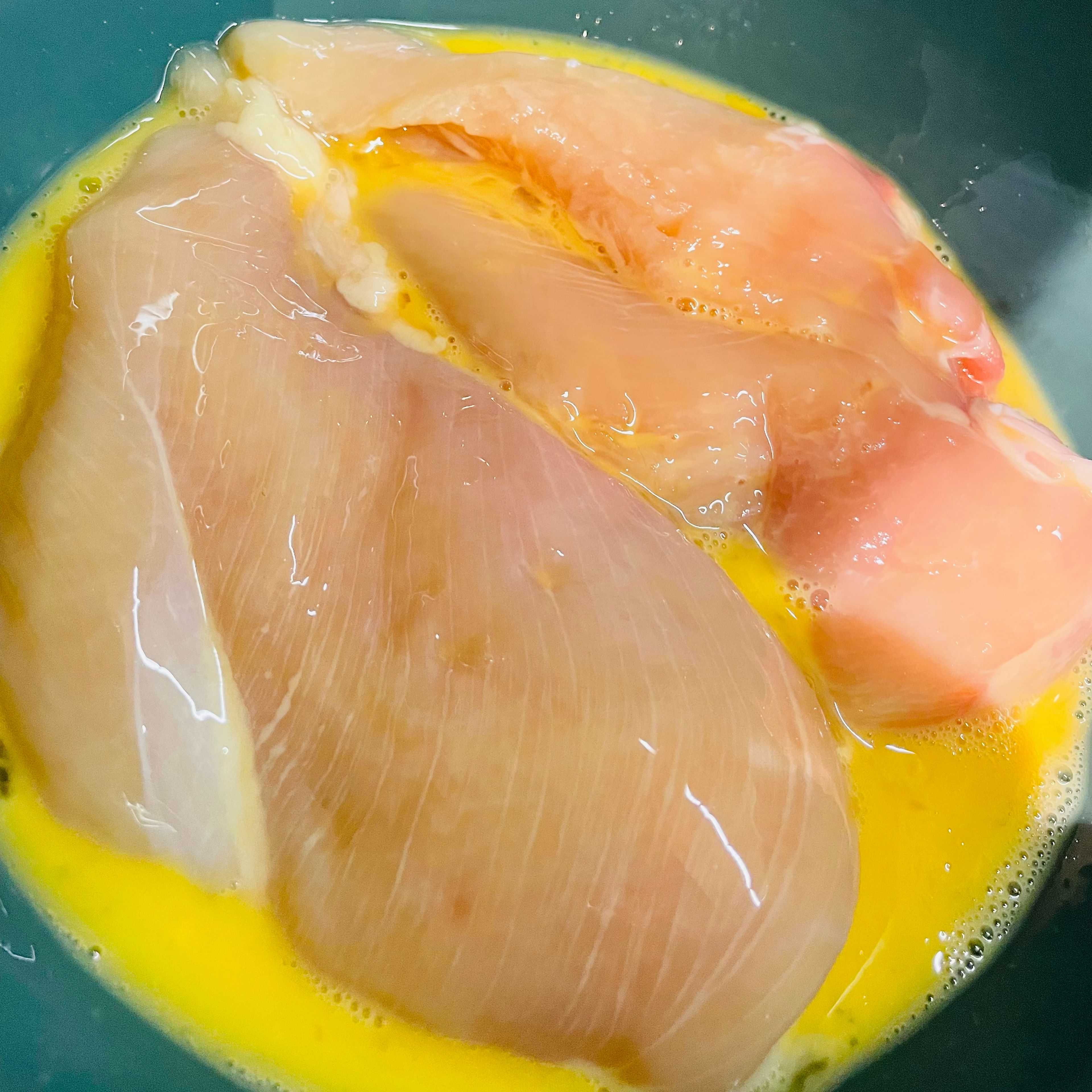 Add in egg to chicken breast