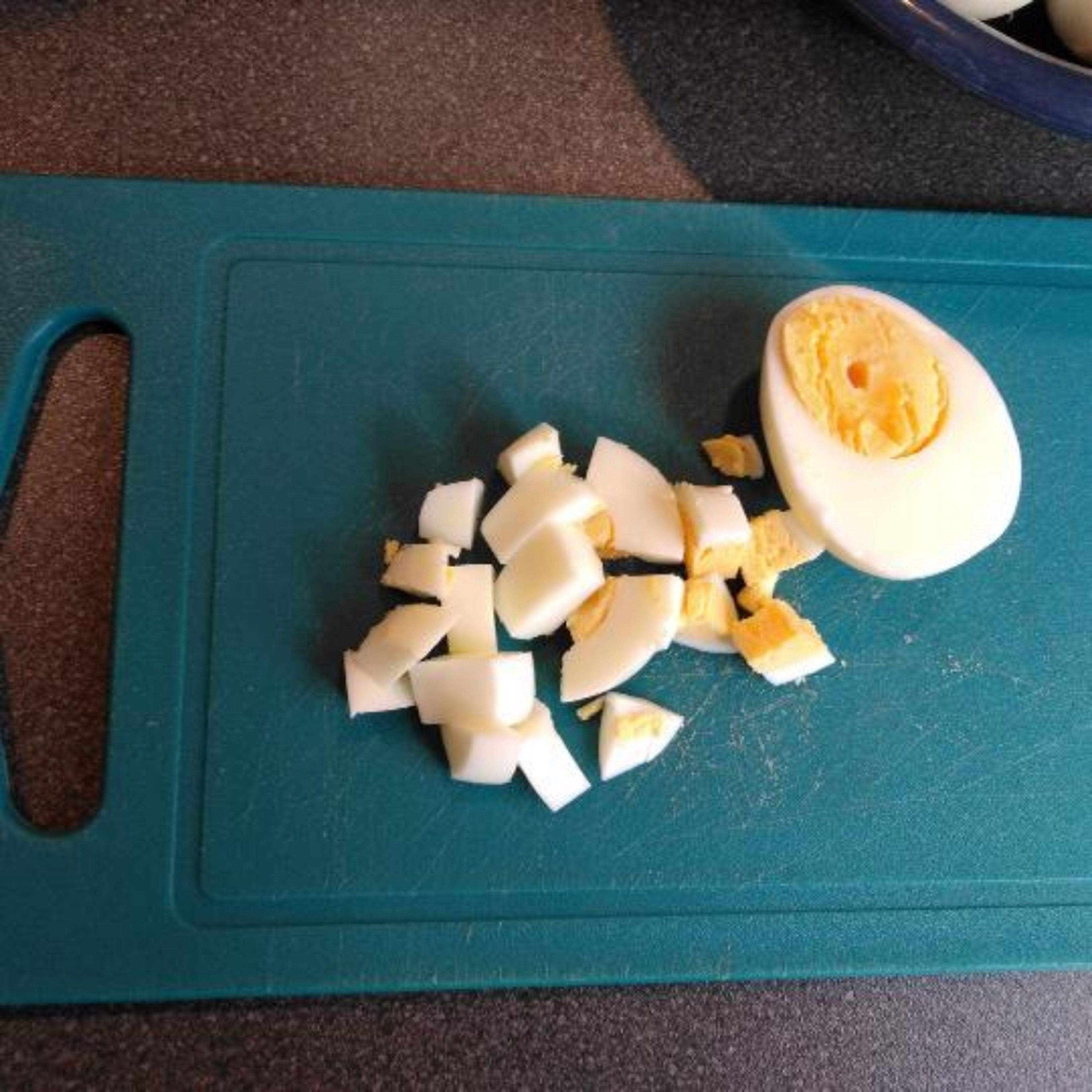 Boil eggs until cooked through, let cool, and dice into cubes.