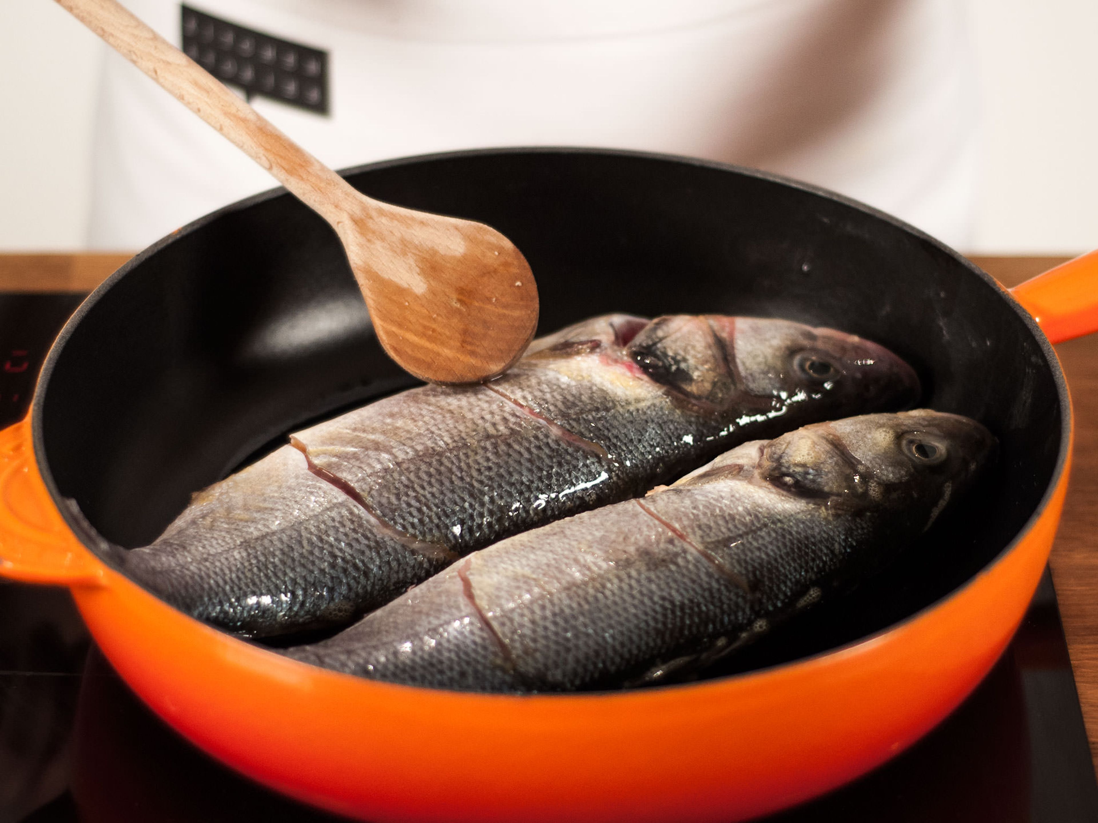 Preheat vegetable oil in a pan on medium-low heat. Place fish into pan and fry for approx. 1 min. on each side.